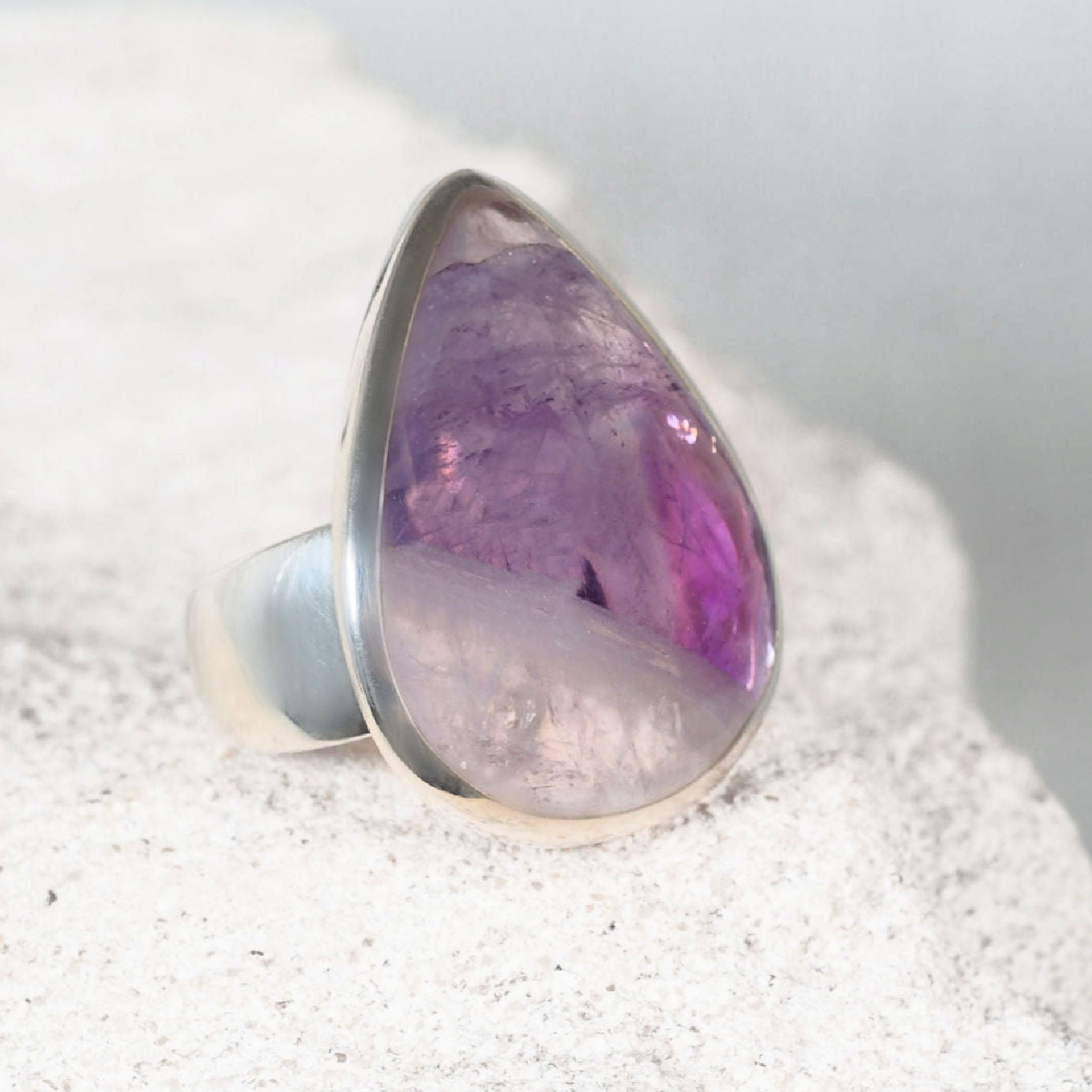 The ‘Mary’ amethyst silver ring with a teardrop triangular amethyst cabochon, light purple with a small clear section