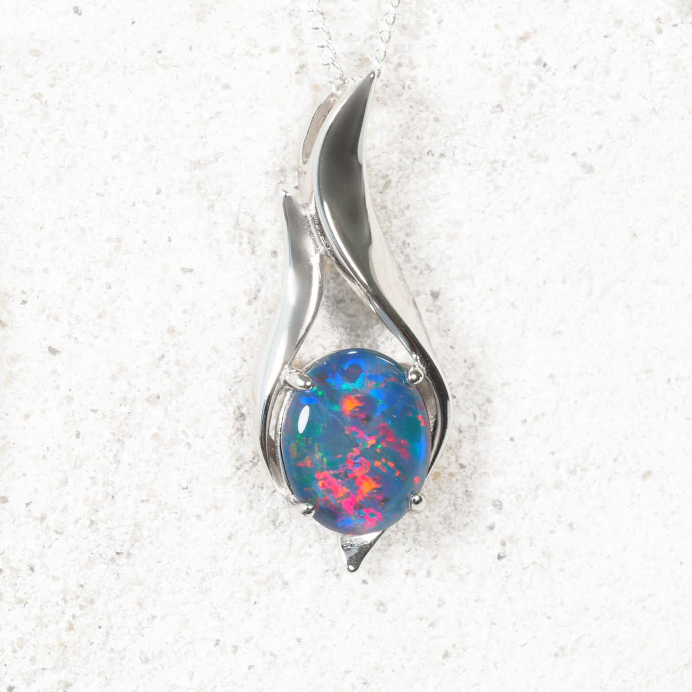 Multi-colour Australian oval opal pendant in sculptural sterling silver setting
