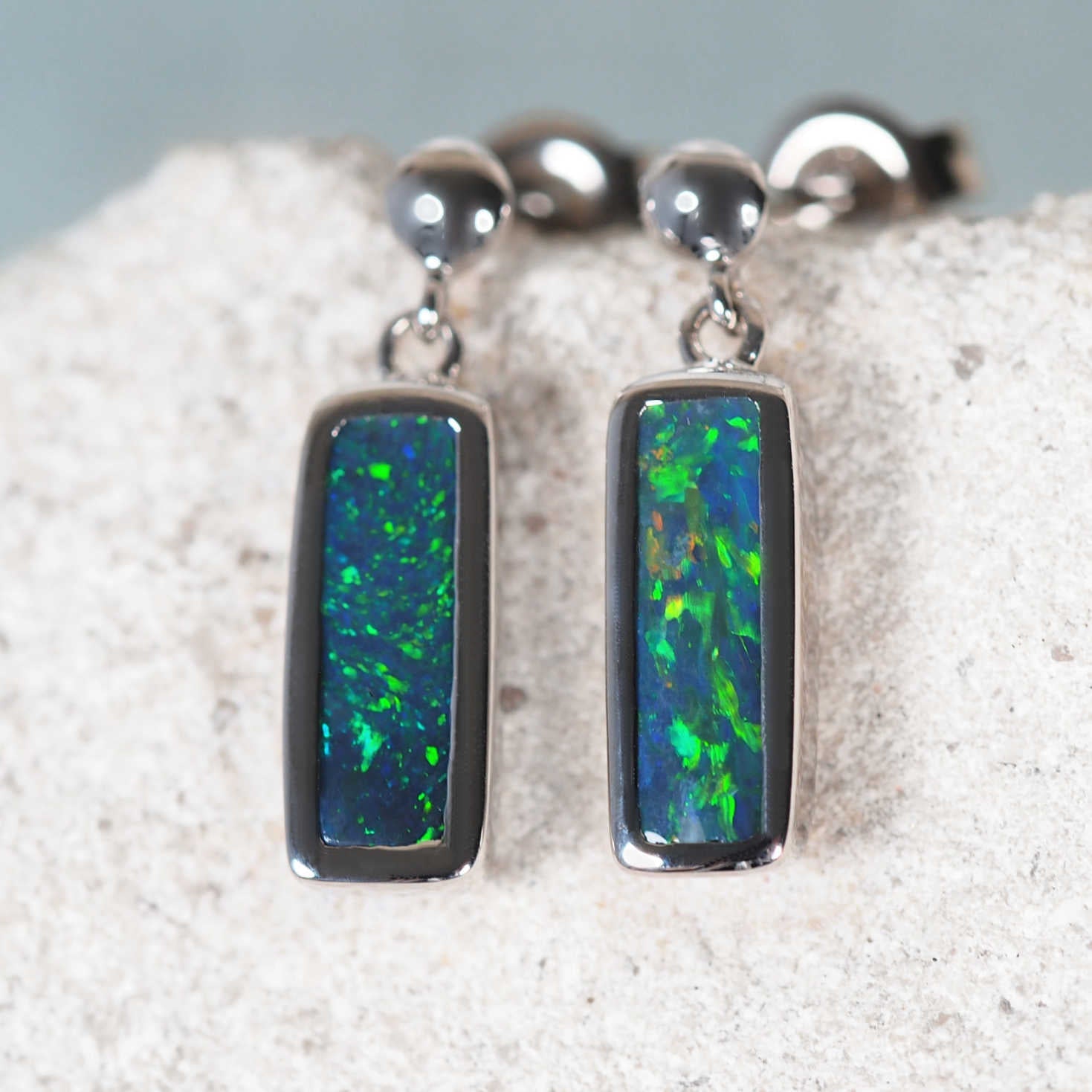 'Meliana' black opal earrings set in 14ct white gold with green, blue and red Lightning Ridge opals