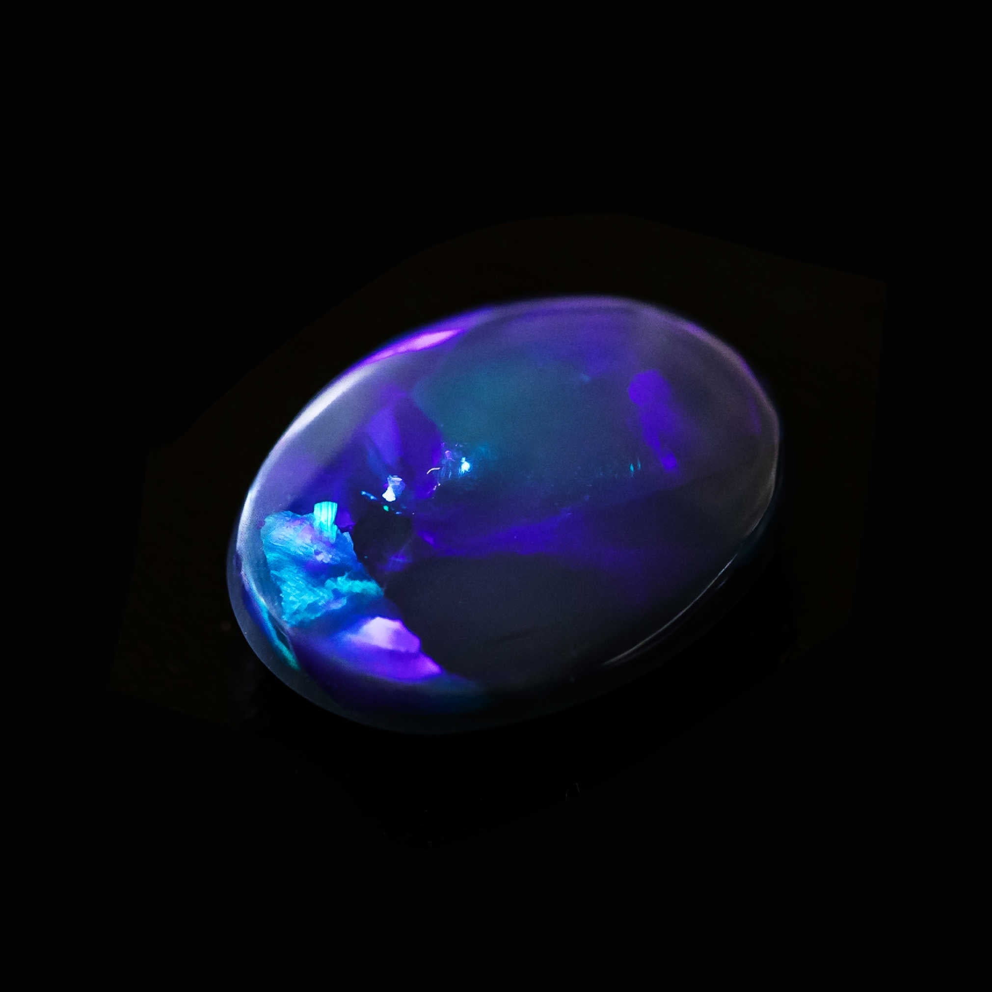 Midnight Mirage black opal with deep blue and green flagstone pattern, oval cut gemstone from Lightning Ridge.