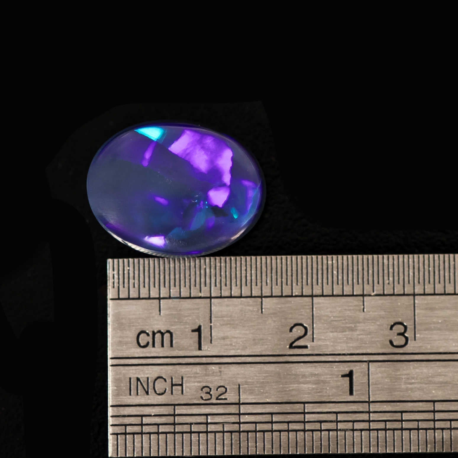 Ethically sourced Lightning Ridge black opal gemstone with shimmering midnight hues and radiant fire