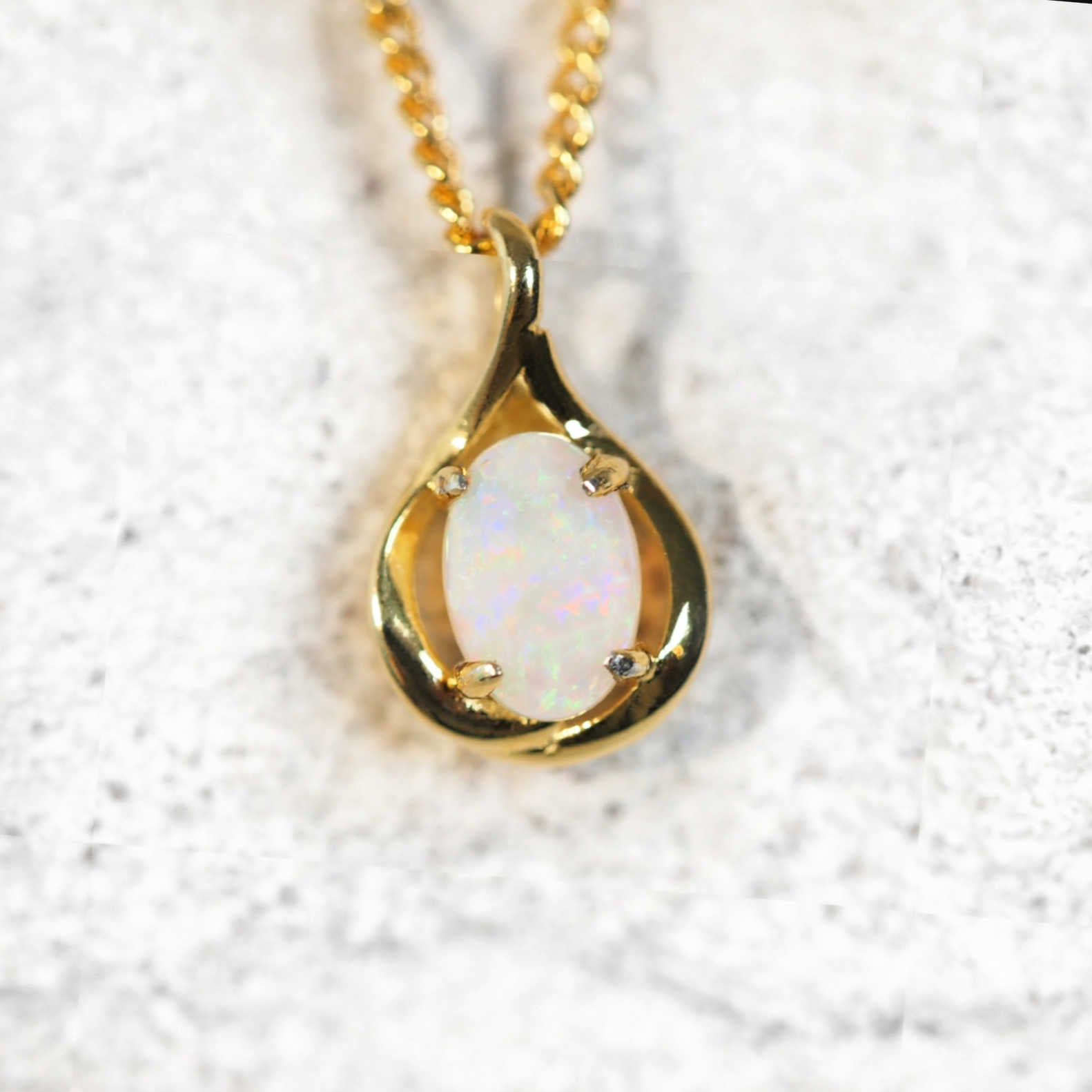 colourful oval opal set in a gold plated silver pendant