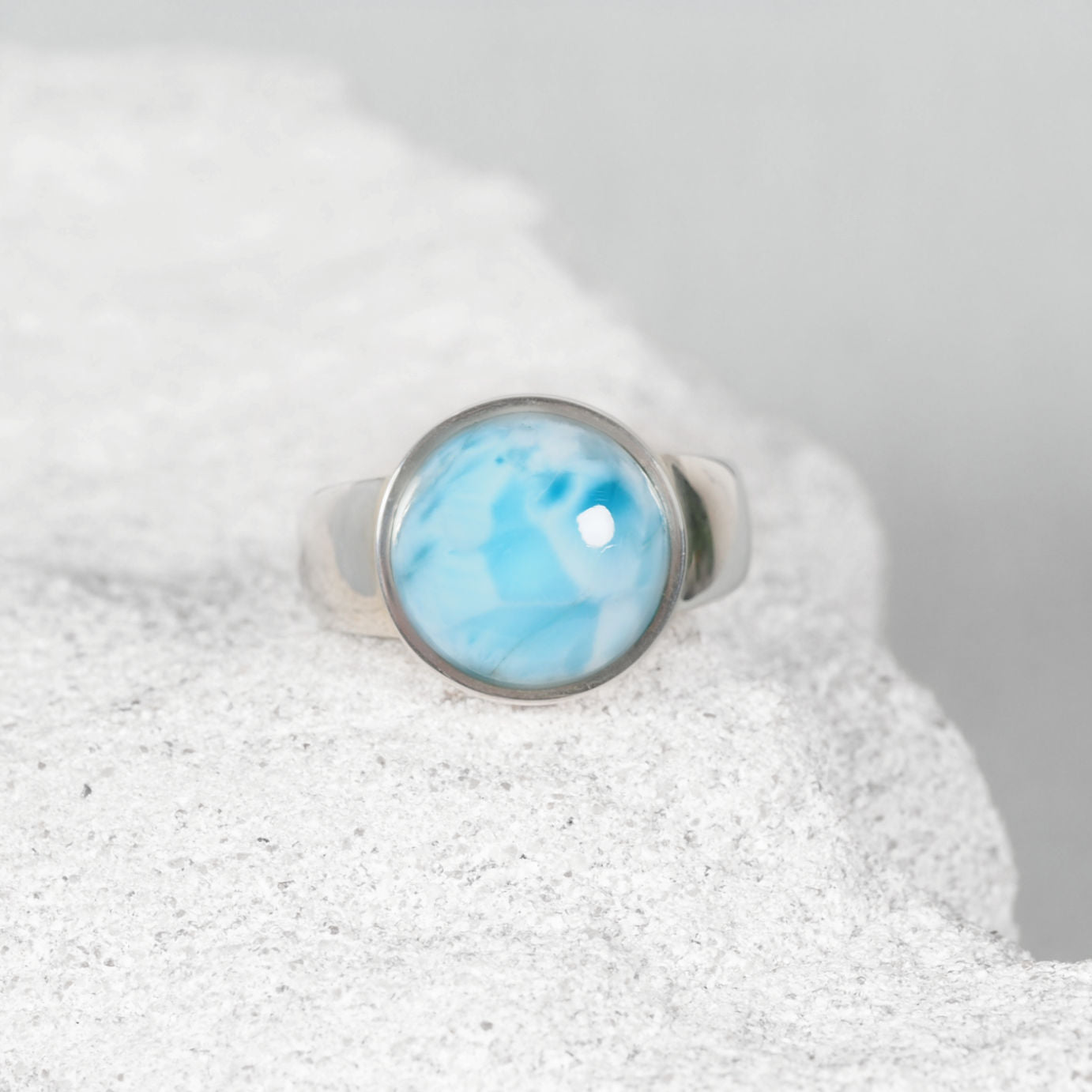‘Mimi’ Larimar ring with a petite round blue cabochon accented by delicate white, set in polished silver