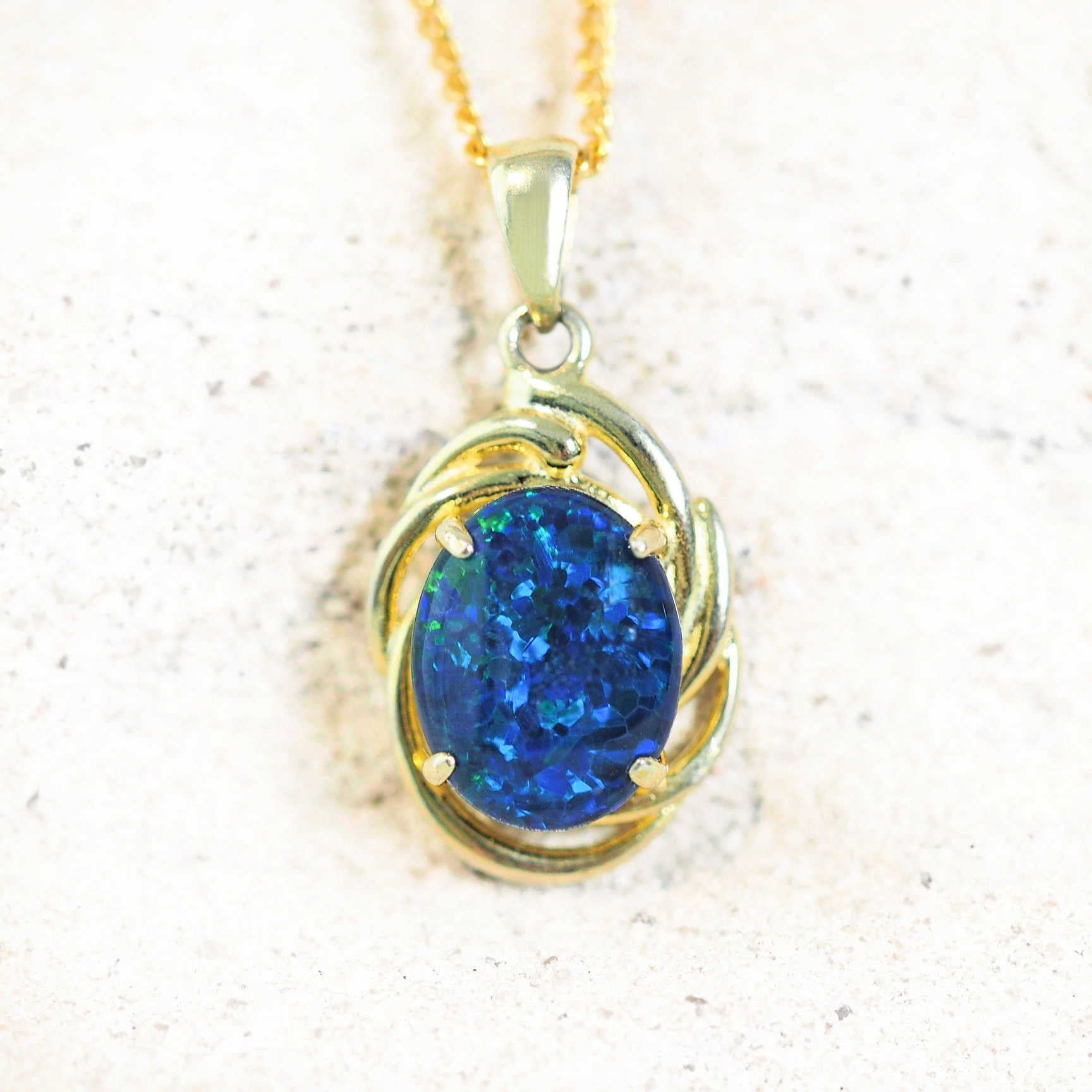 Gold-plated silver pendant featuring a vibrant blue opal gemstone