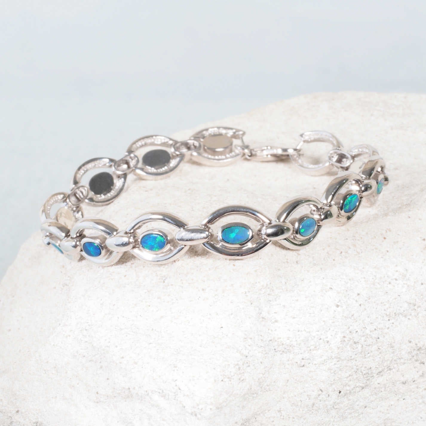 Mina opal bracelet with eleven oval blue green doublet opals in sterling silver