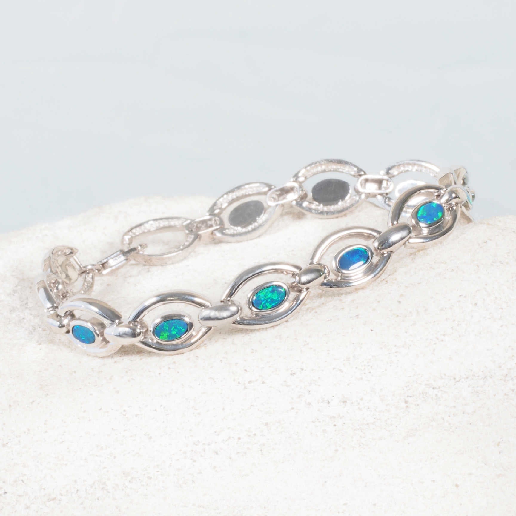 Australian doublet opal bracelet featuring vivid blue and green stones in a chain link design