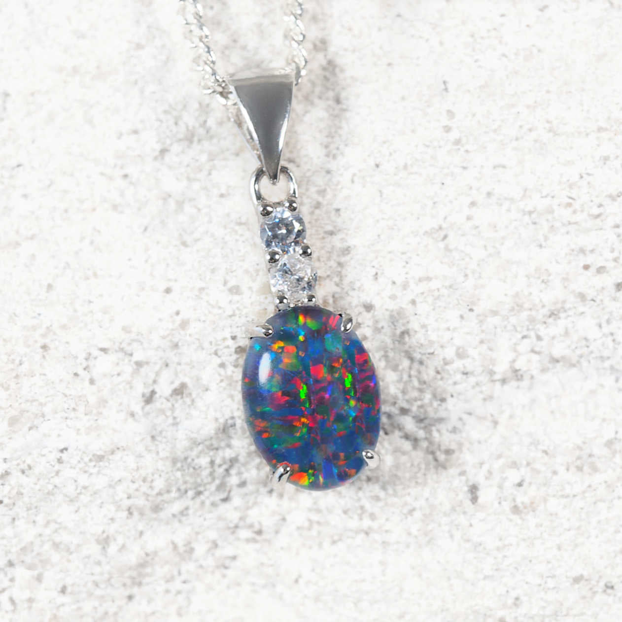 ‘Moana Grande’ sterling silver opal pendant with claw-set oval Australian triplet opal in vibrant multi-coloured tones and two diamanté accents