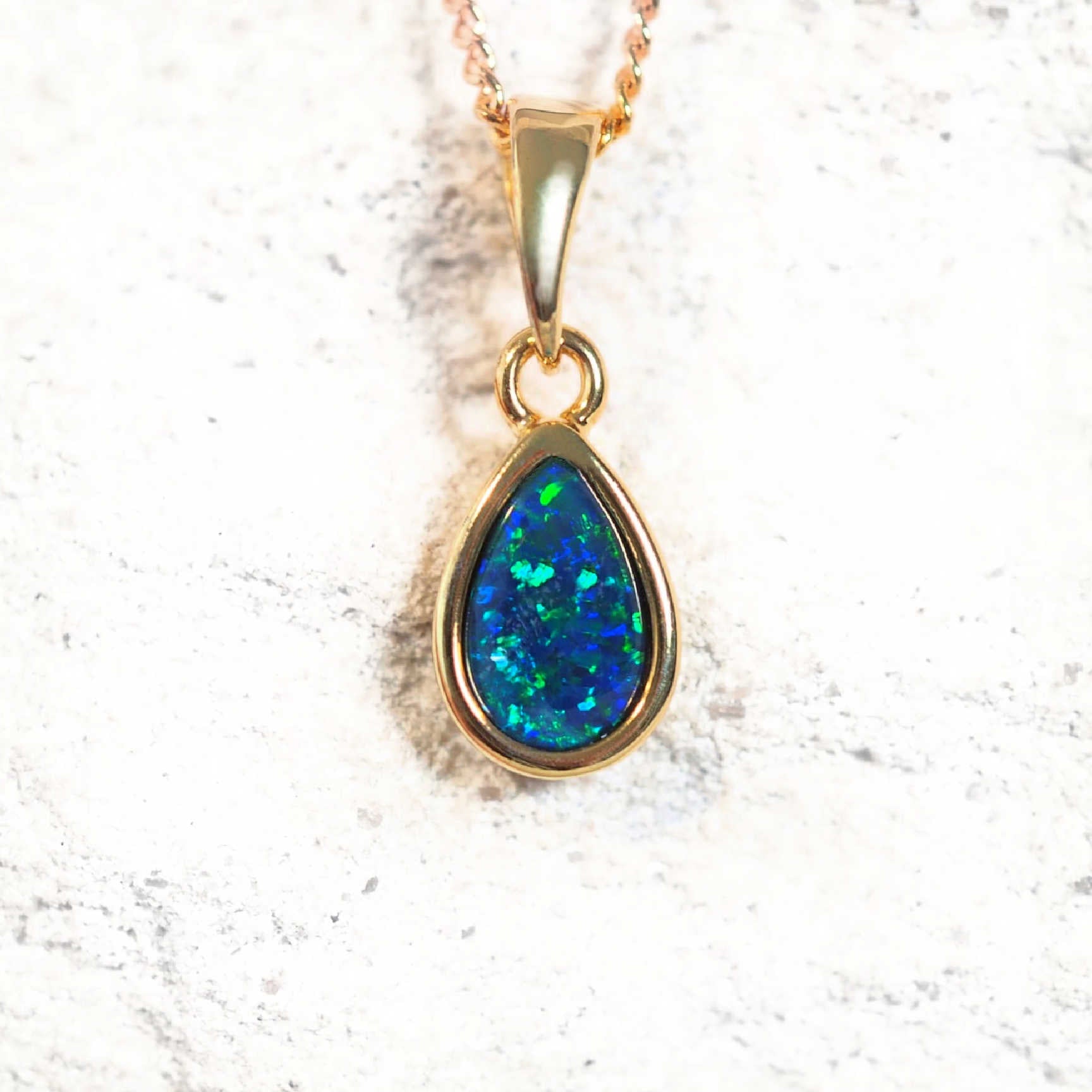 Gold-plated silver teardrop-shaped opal pendant necklace with bezel-set blue and green Australian triplet opal, shown with matching chain.