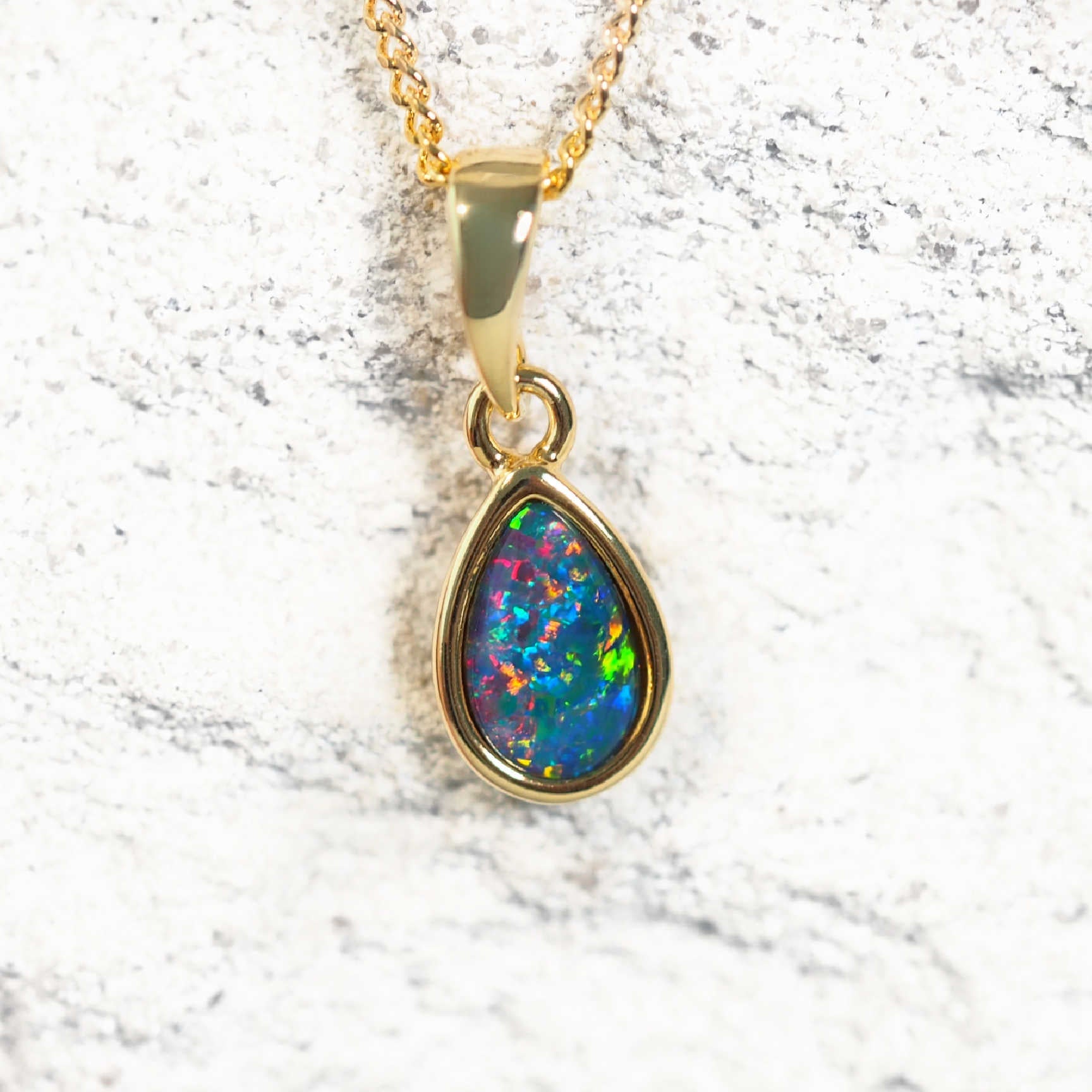 Gold-plated silver teardrop-shaped opal pendant necklace with bezel-set multi-coloured Australian triplet opal, shown with matching chain.