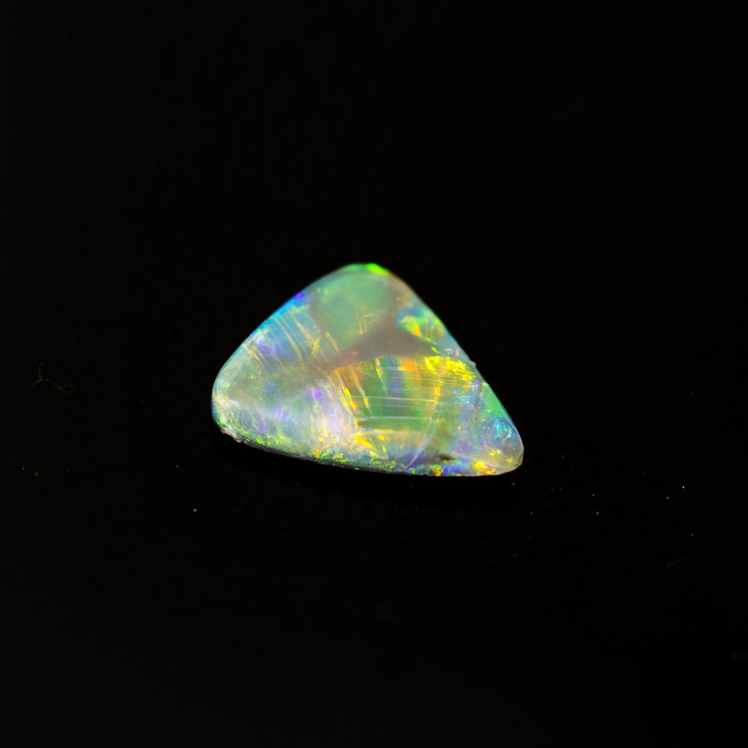 Triangular black crystal opal with vivid multi-colour flashes from Lightning Ridge