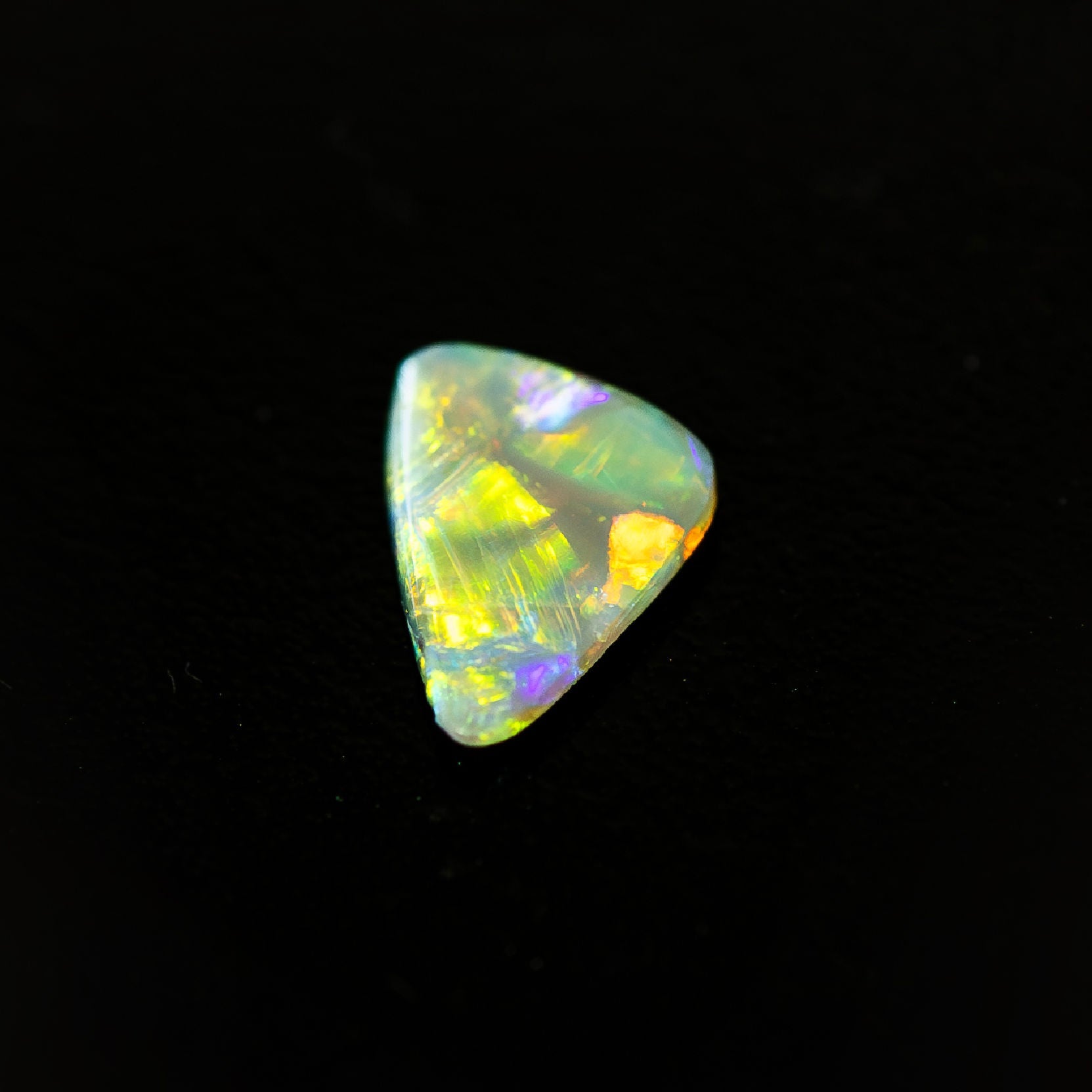 Natural Australian black opal with dark body tone and bright colour play