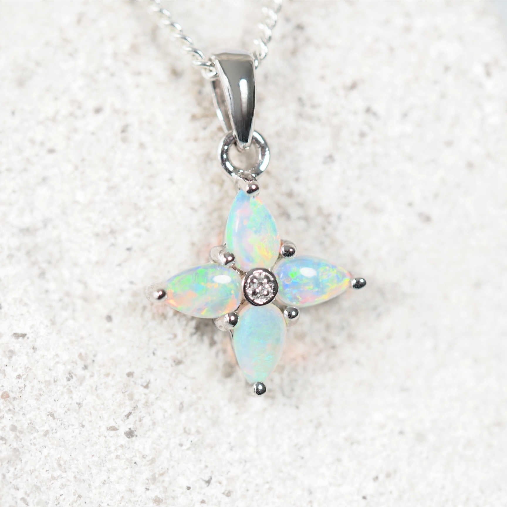blue-green opal pendant set in white gold with one diamond
