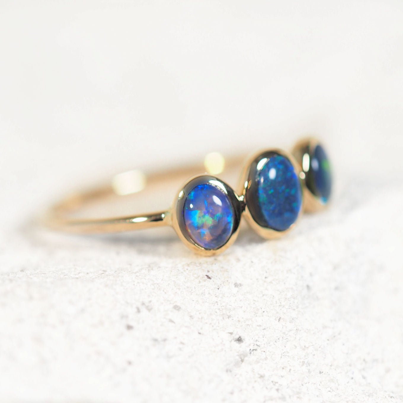 Luxury black opal ring – handcrafted 14ct yellow gold band featuring three solid Lightning Ridge opals