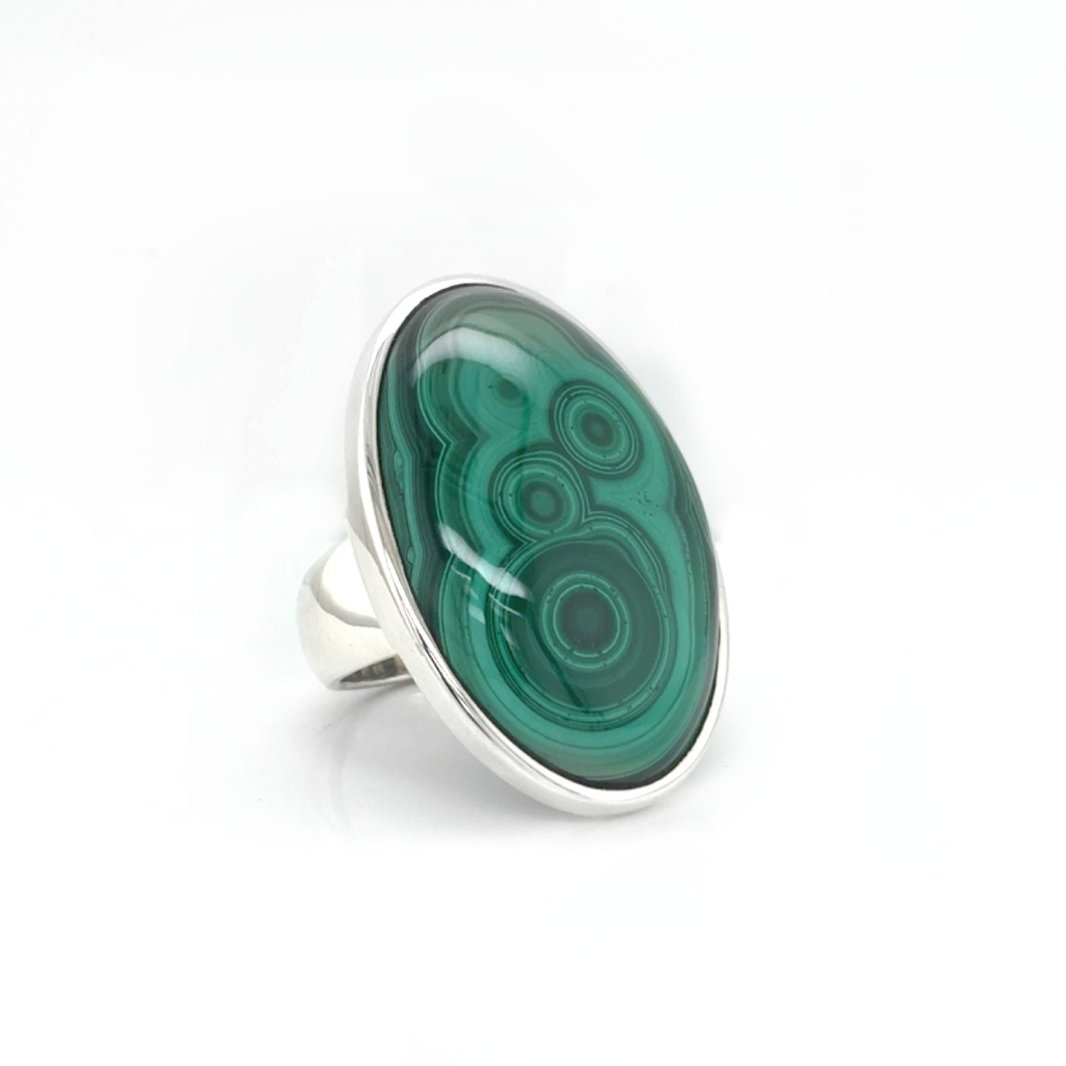 Elegant silver bezel-set Malachite ring shown on hand for scale