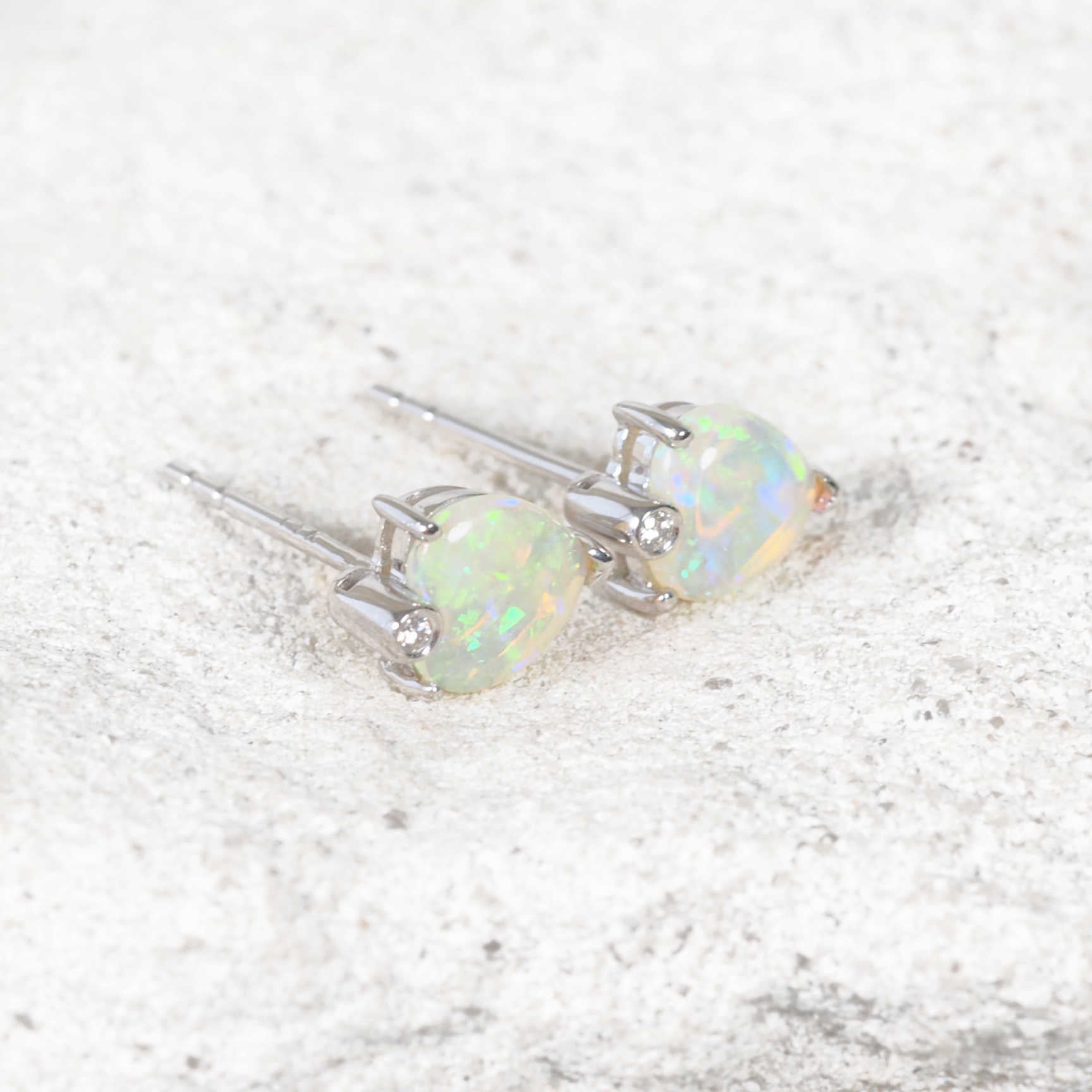 Side view of the ‘Ocean Heart’ opal earrings highlighting their unique opal shapes and ocean-inspired brilliance