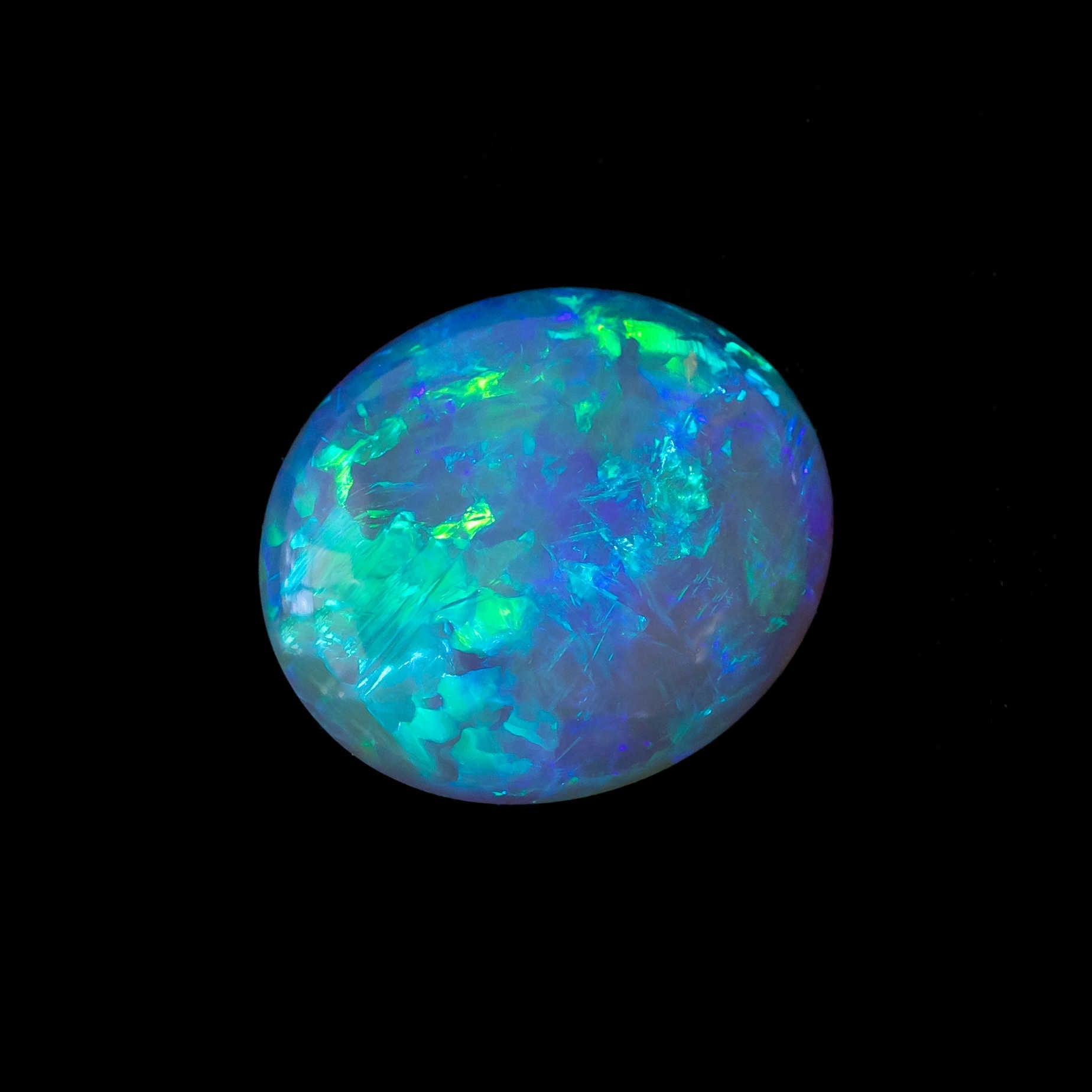 Translucent crystal opal gemstone glowing with ocean-inspired hues