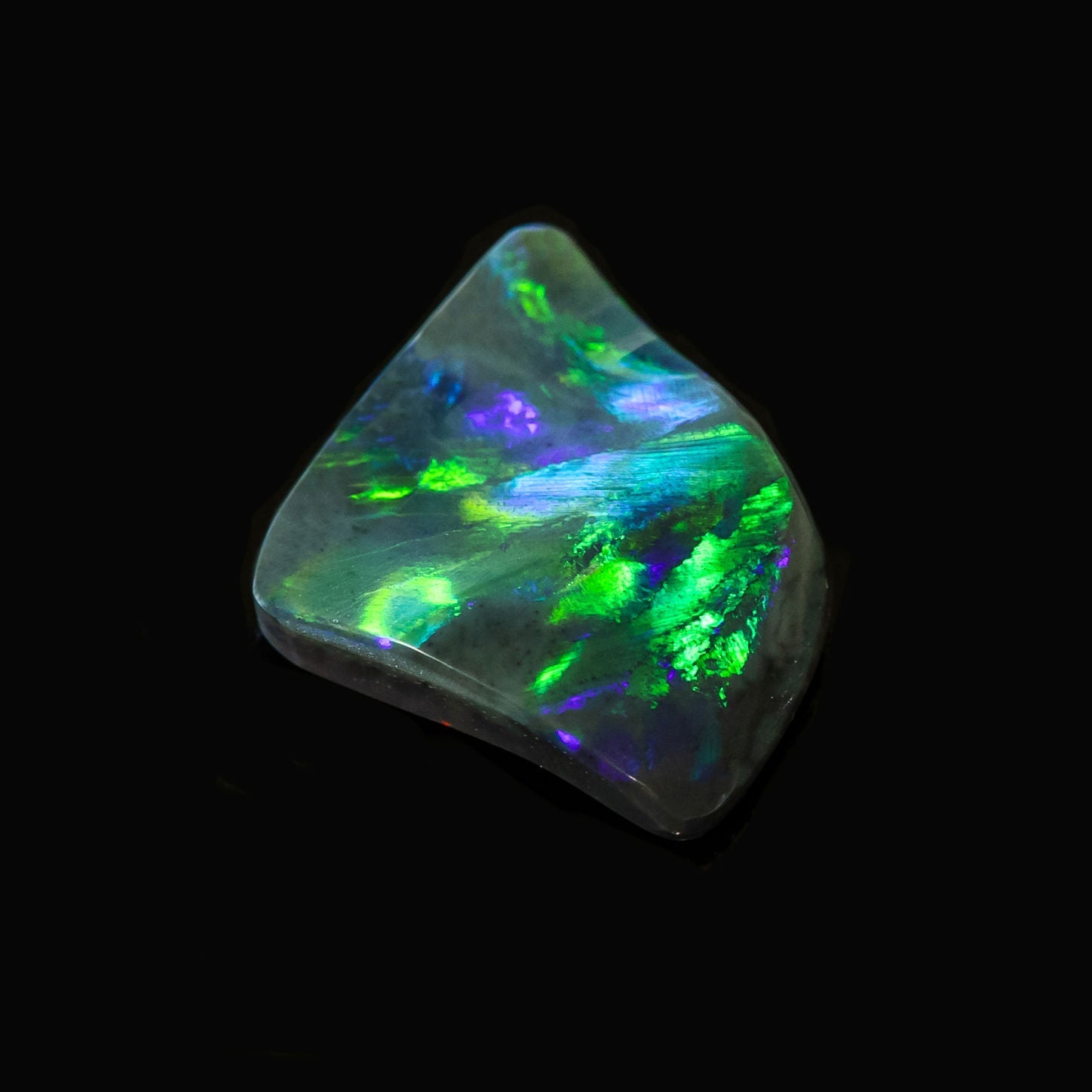 Ethically sourced Lightning Ridge opal with oceanic hues and unique shape