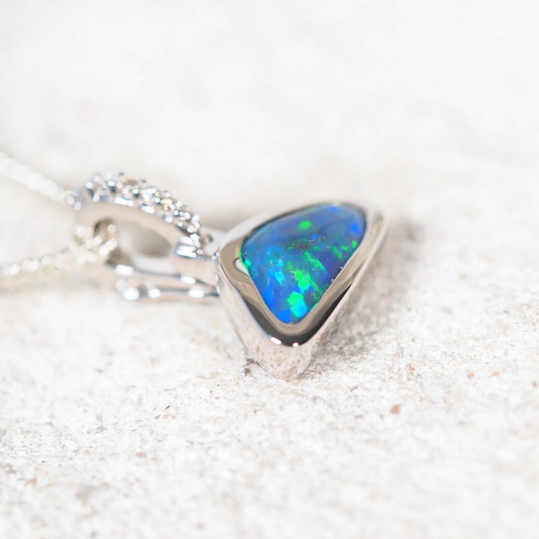 Black opal pendant on a white background
