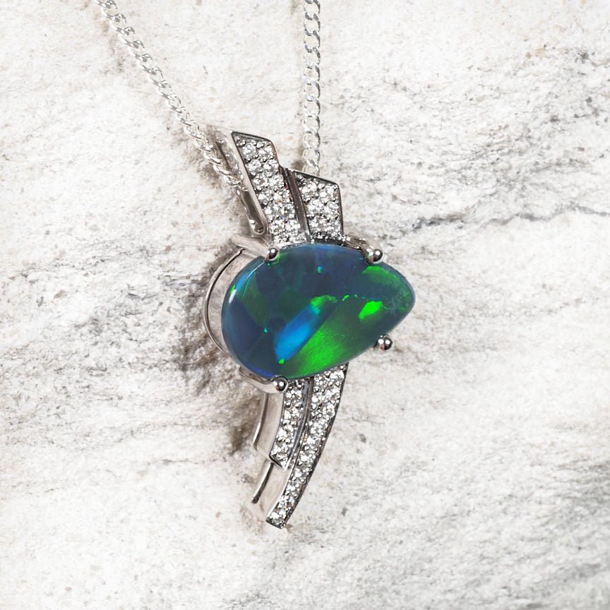 Teardrop-shaped black opal necklace in white gold with diamond accents