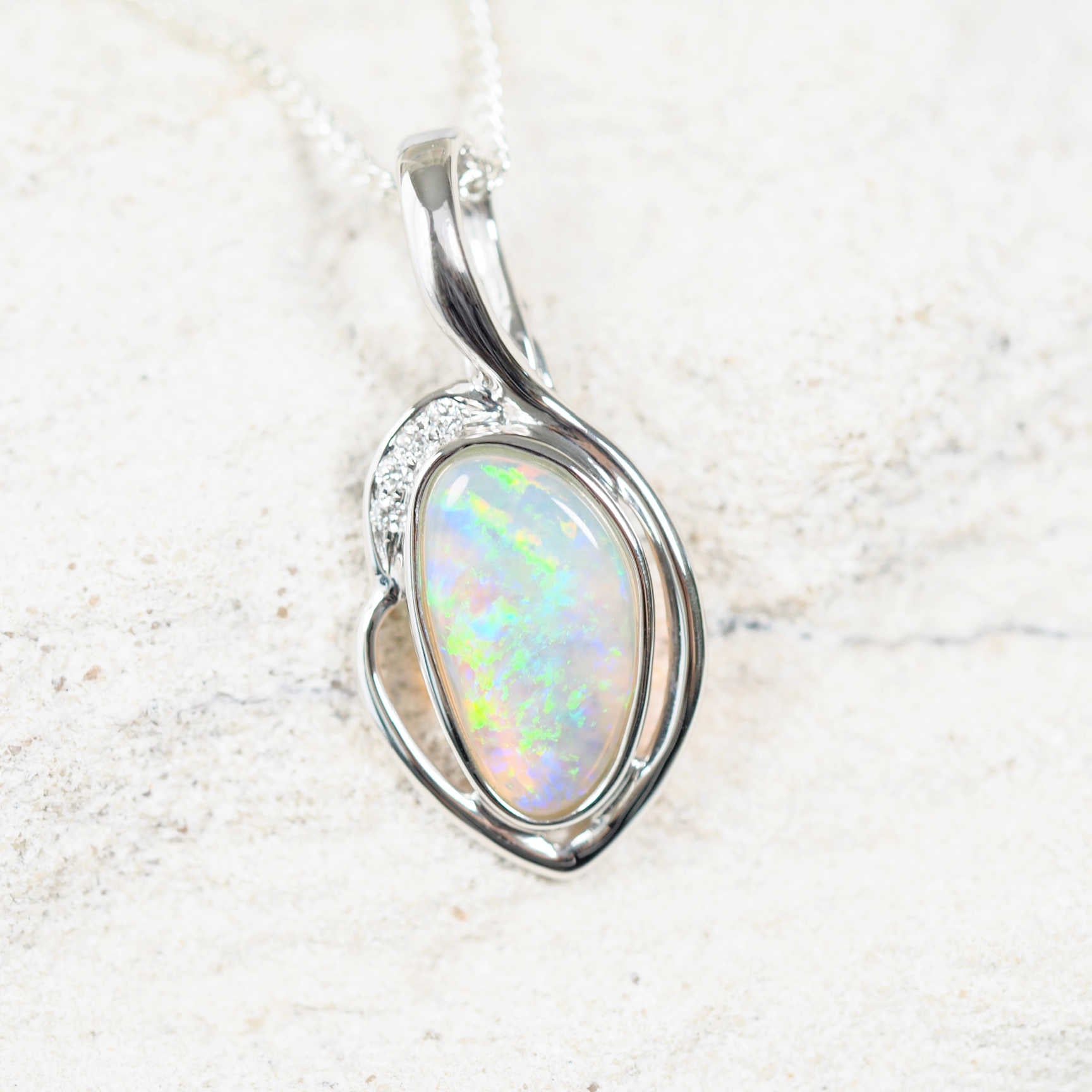 Ophelia opal pendant in 14ct white gold with green South Australian solid crystal opal, freeform-oval shape, and four white diamond accents.