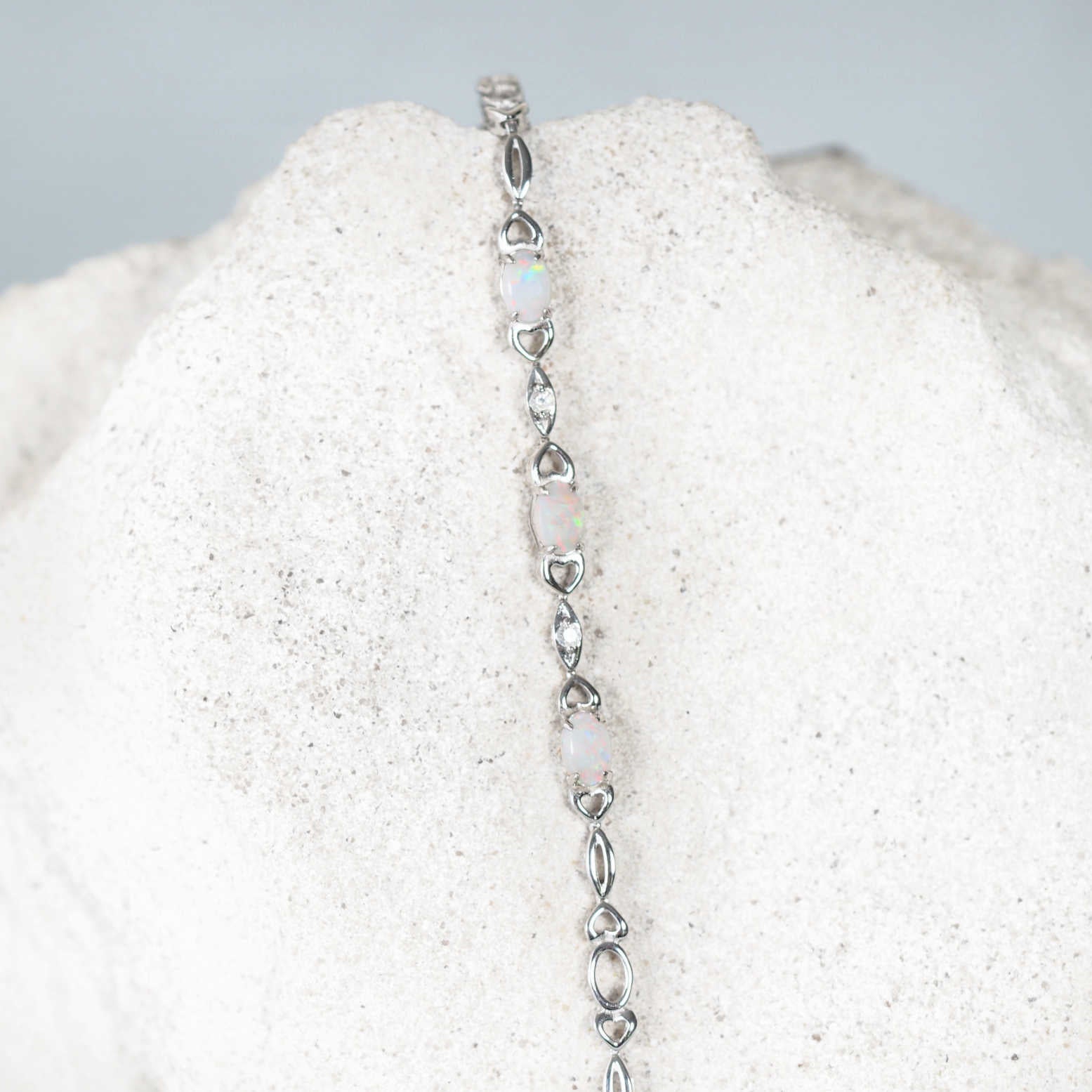 silver opal bracelet with three colourful solid white opals