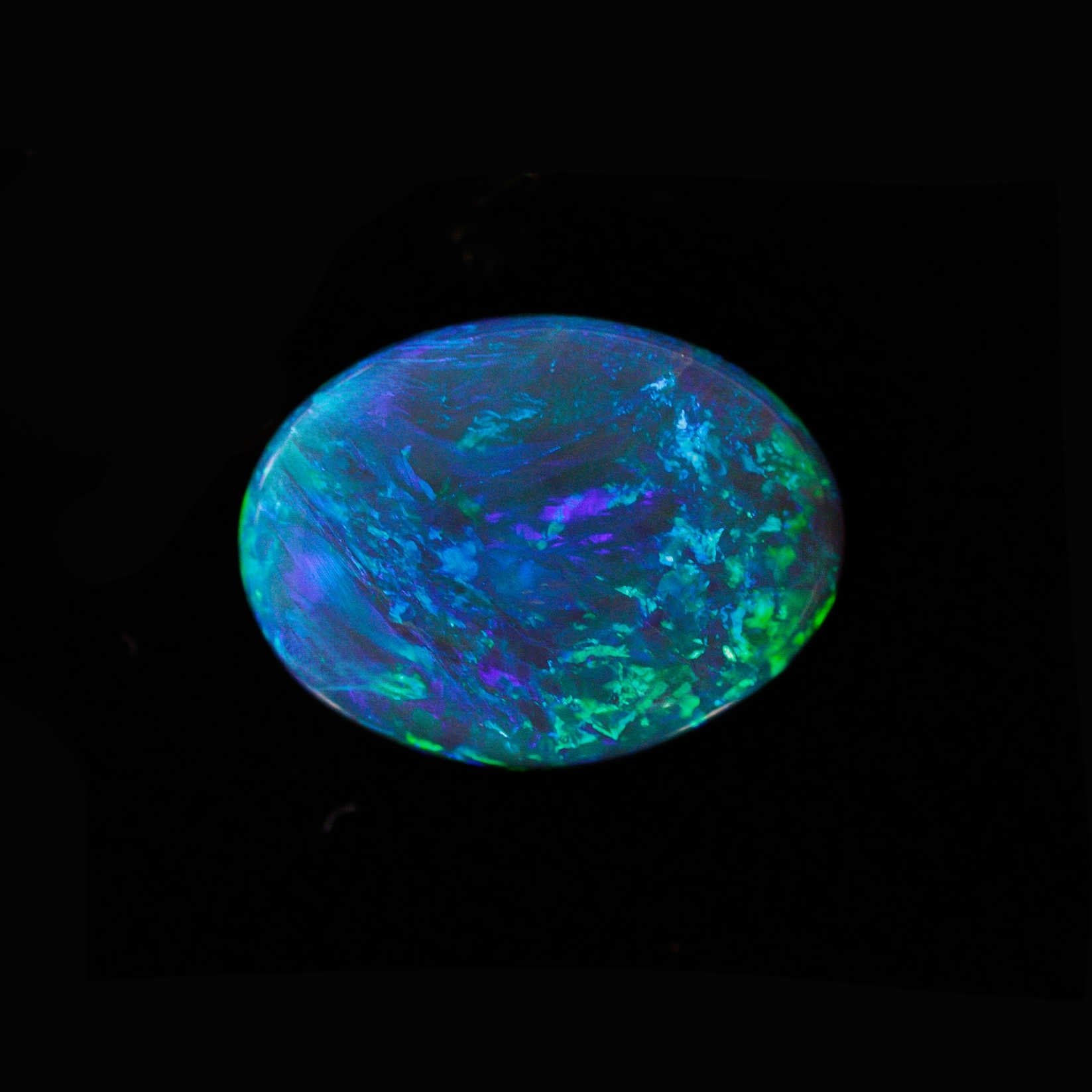 Peacock Dream black opal displaying vibrant blue and green broadflash pattern