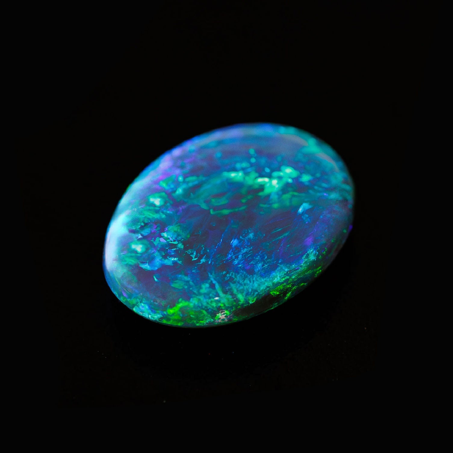 Close-up of Peacock Dream gemstone showing electric blue and emerald tones