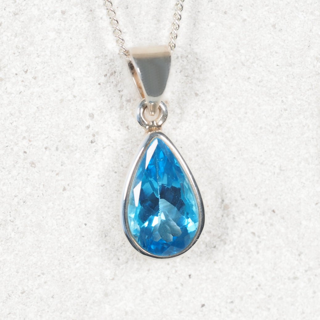 Silver Blue Topaz pendant displaying faceted bright blue gemstone
