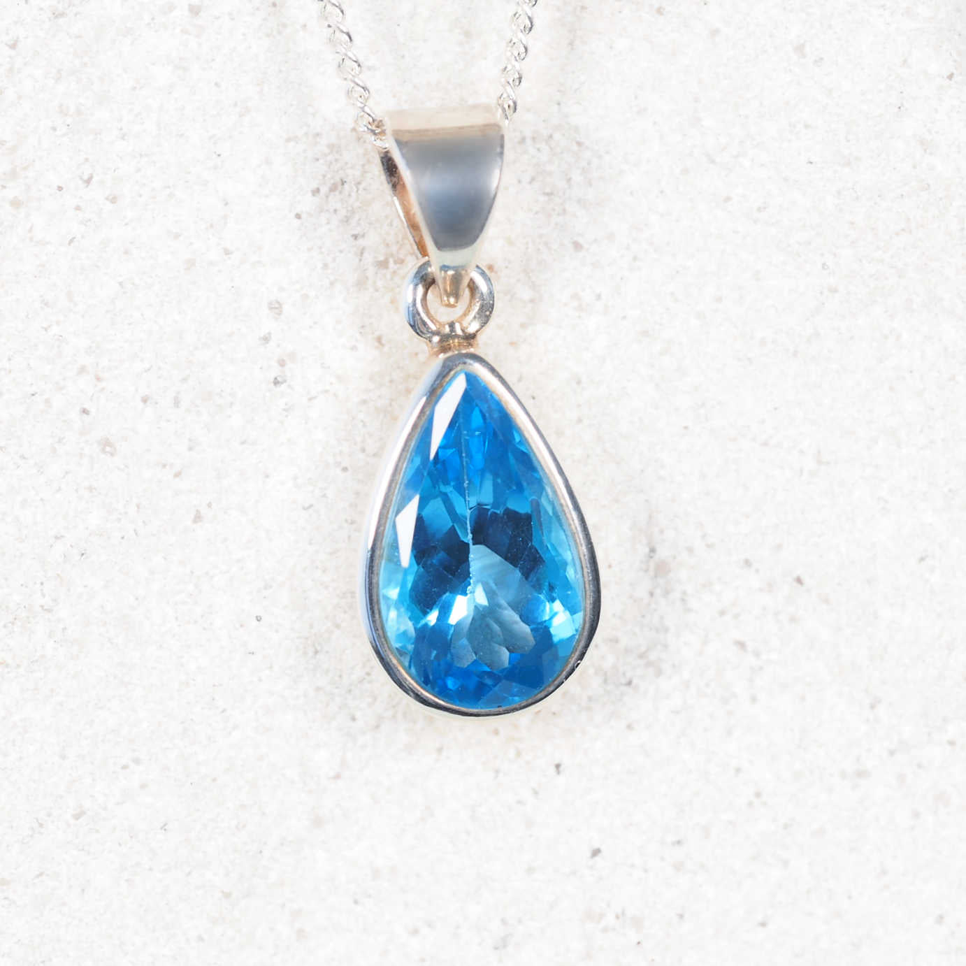 Silver Blue Topaz pendant displaying faceted bright blue gemstone