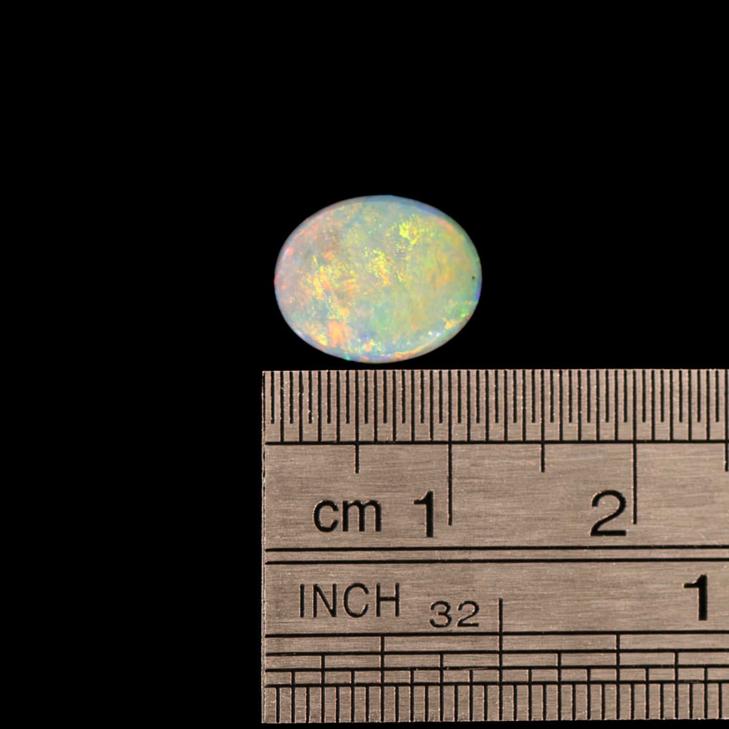 Australian pal stone with a ruler on a black background