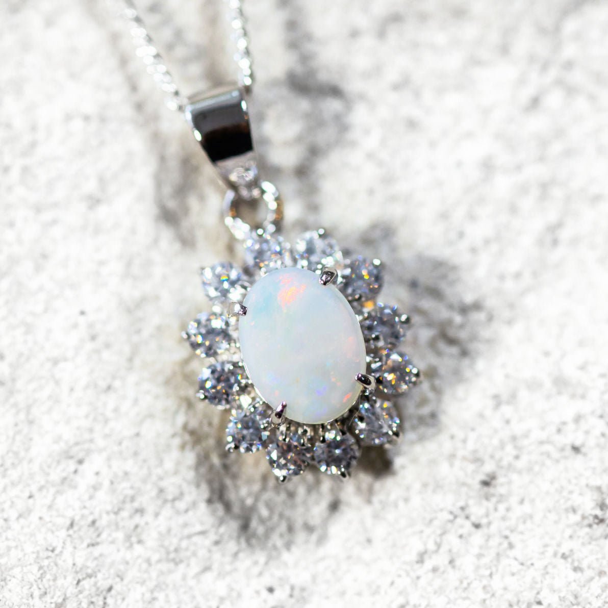 princess design white opal pendant set in sterling silver with crystals