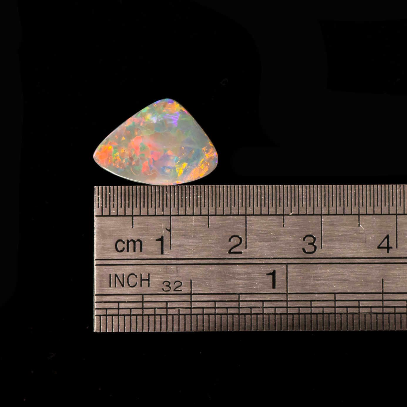 Close-up of natural semi-black opal pair with multicolour brilliance