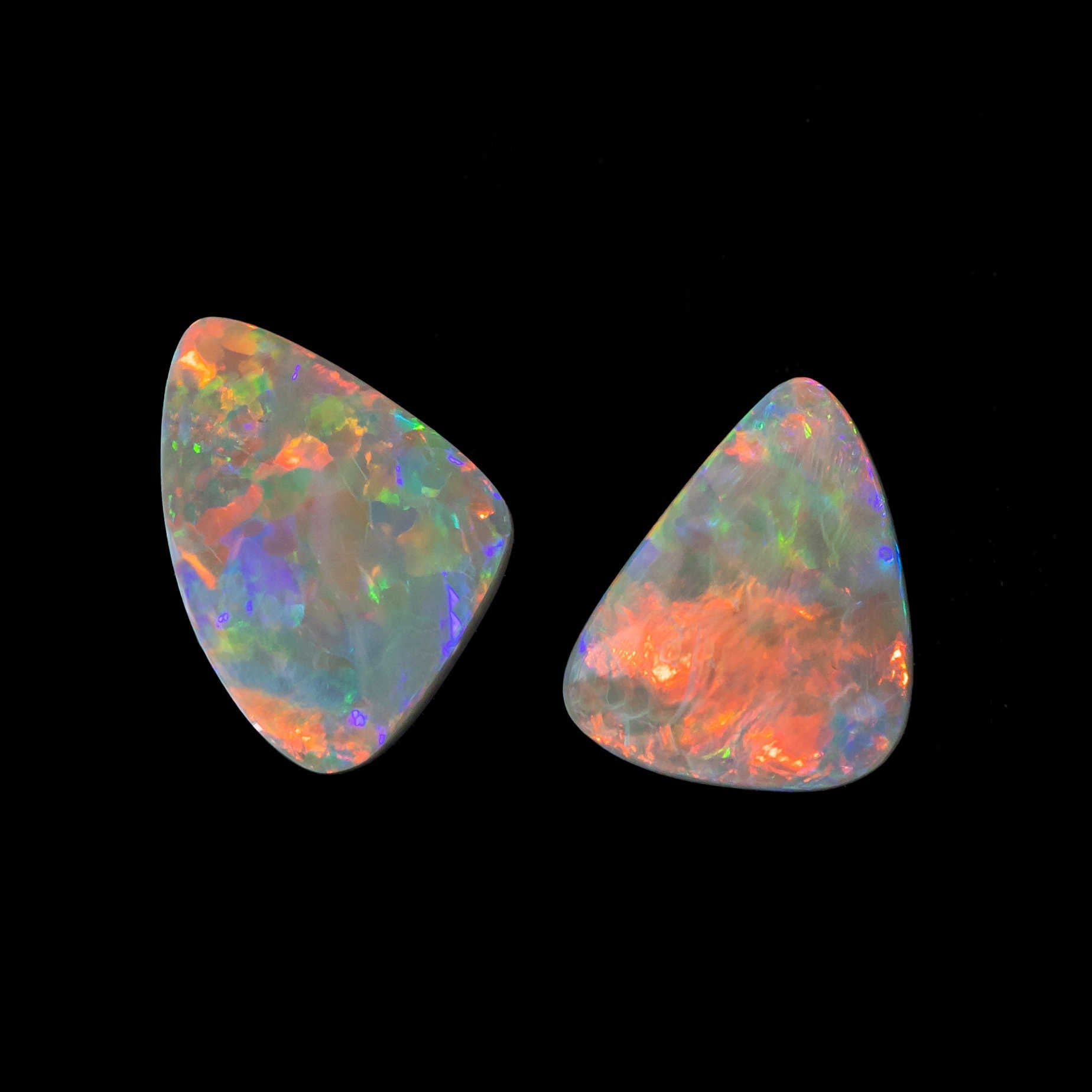Triangular black opal gemstones with vibrant rainbow colour play from Lightning Ridge
