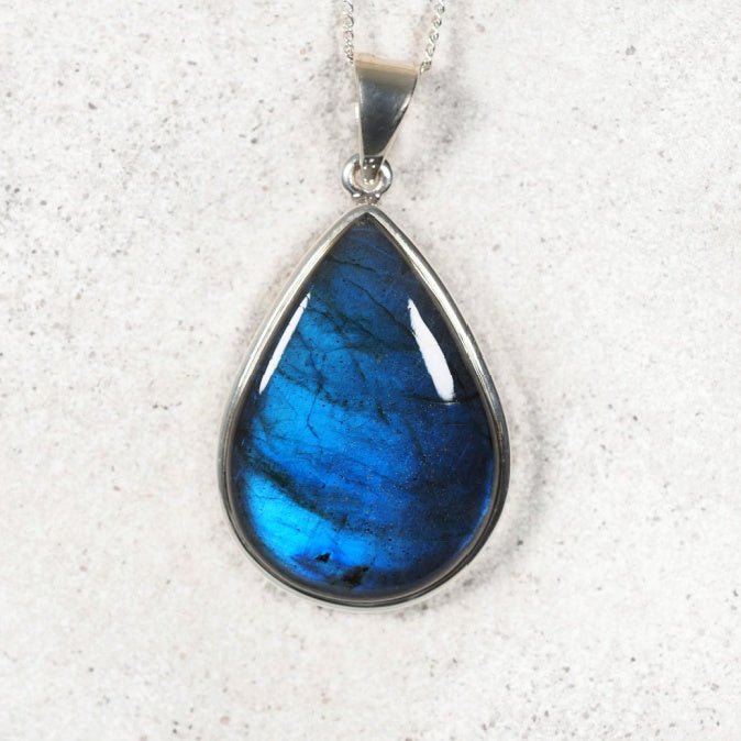 Close-up of Labradorite gemstone pendant showing natural iridescent colors.