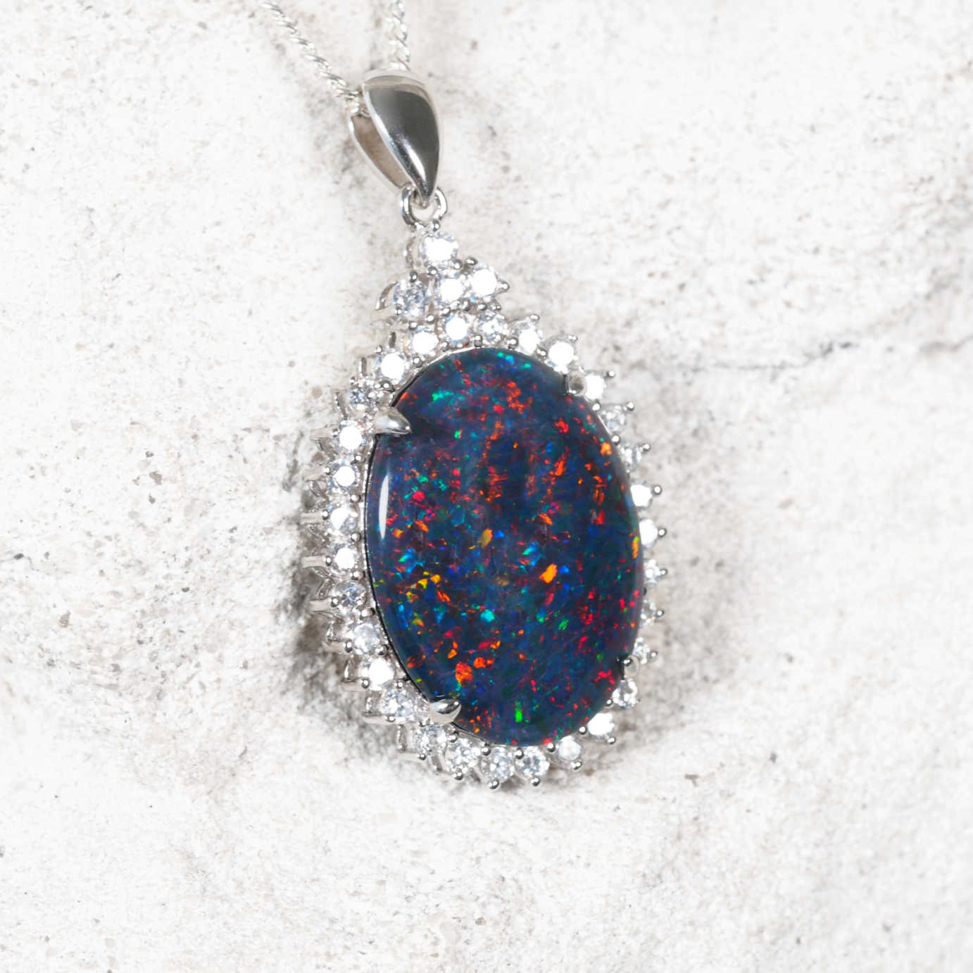 Elegant sterling silver opal necklace pendant featuring multi-coloured Australian triplet opal with dazzling diamanté halo