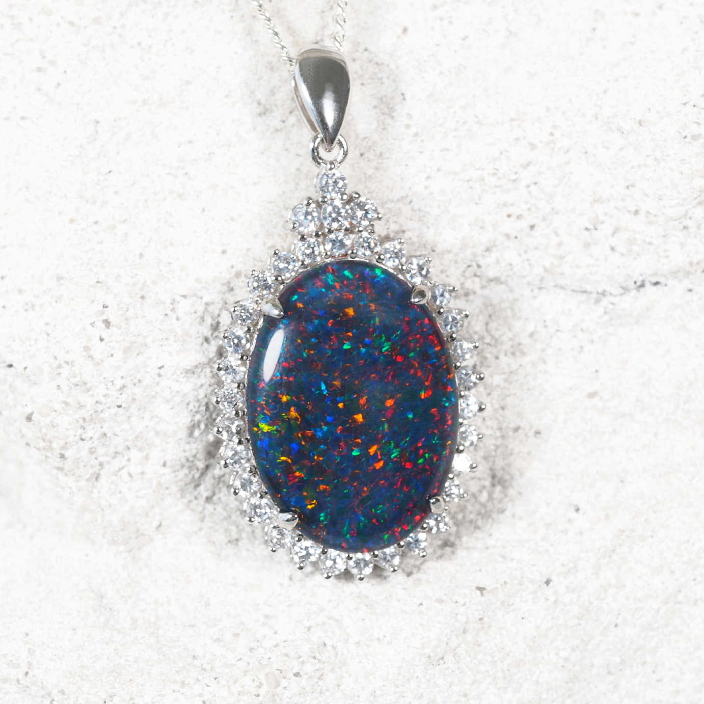 ‘Radiance Deux’ sterling silver opal pendant with dark claw-set oval Australian triplet opal surrounded by 34 sparkling diamantés