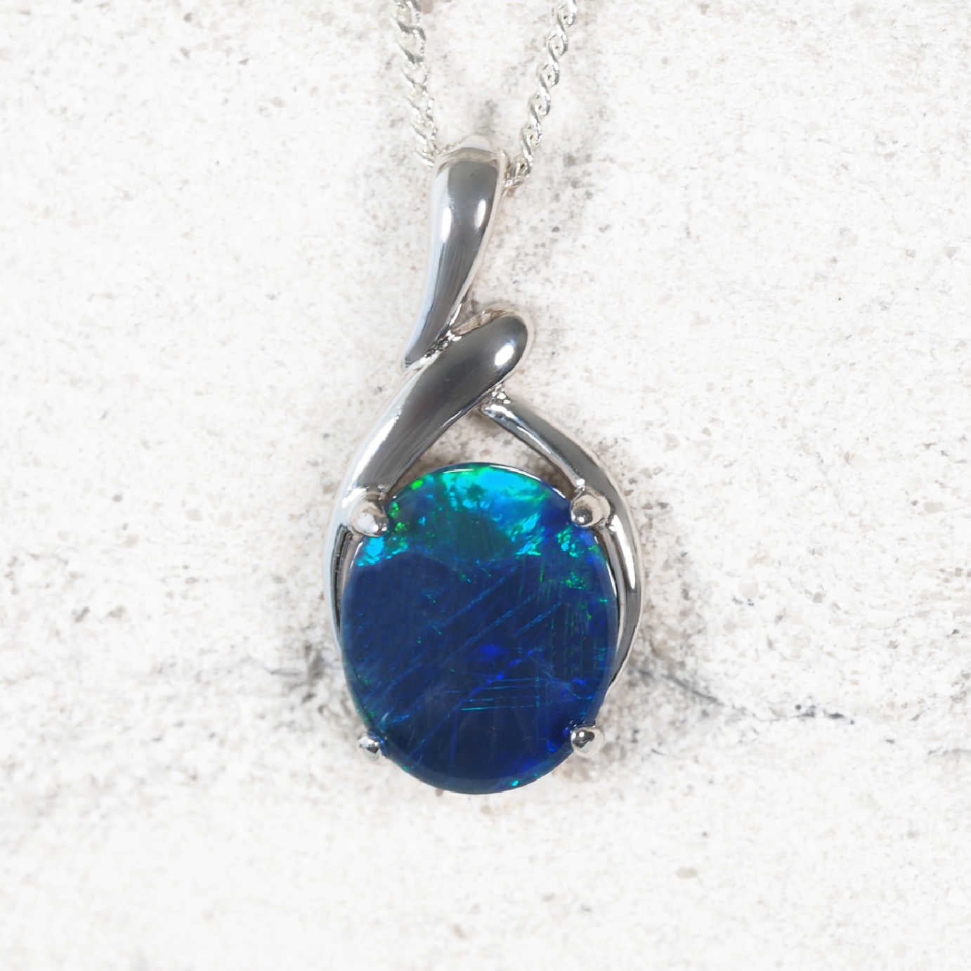 ‘Sahar Blue’ sterling silver statement opal pendant with oval claw-set Australian triplet opal in vivid blue and green hues