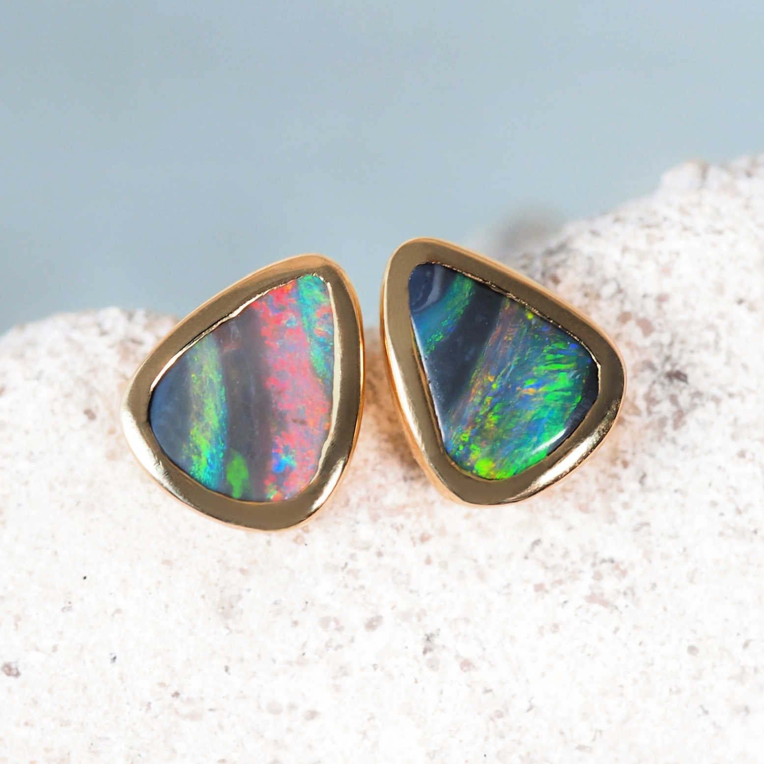 Triangular black opal stud earrings set in 14ct yellow gold