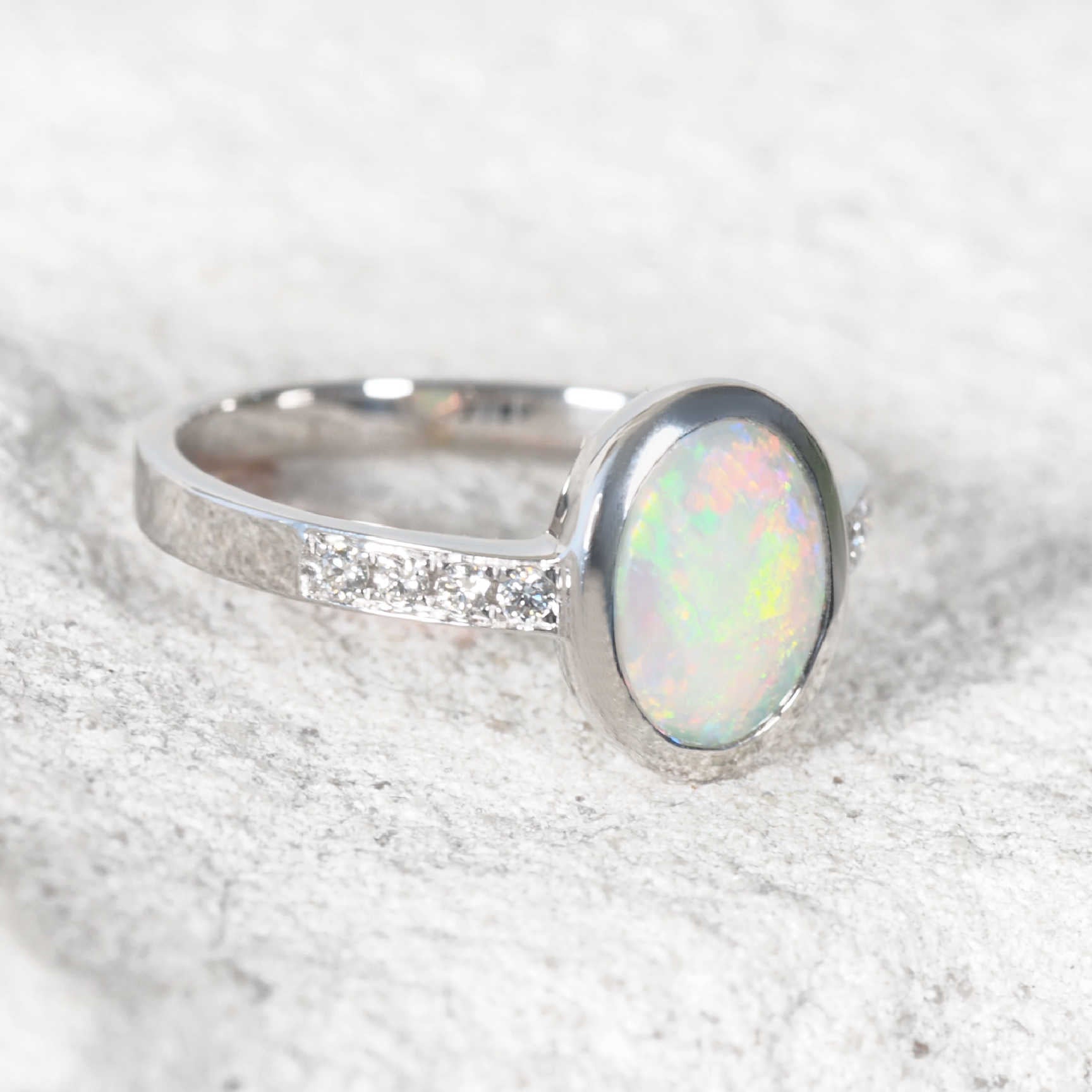 Australian crystal opal ring with eight shoulder-set diamonds