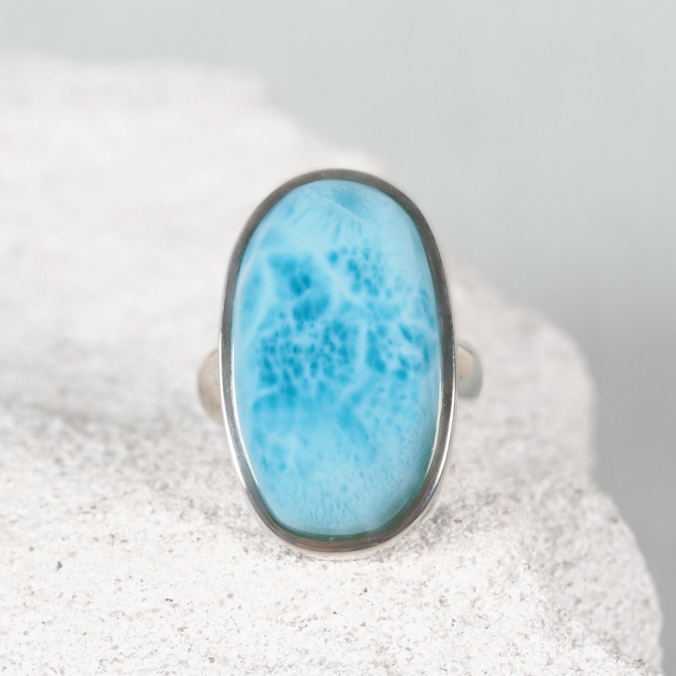The 'Seraphina' oval Larimar gemstone ring featuring sky-blue tones and natural white patterns