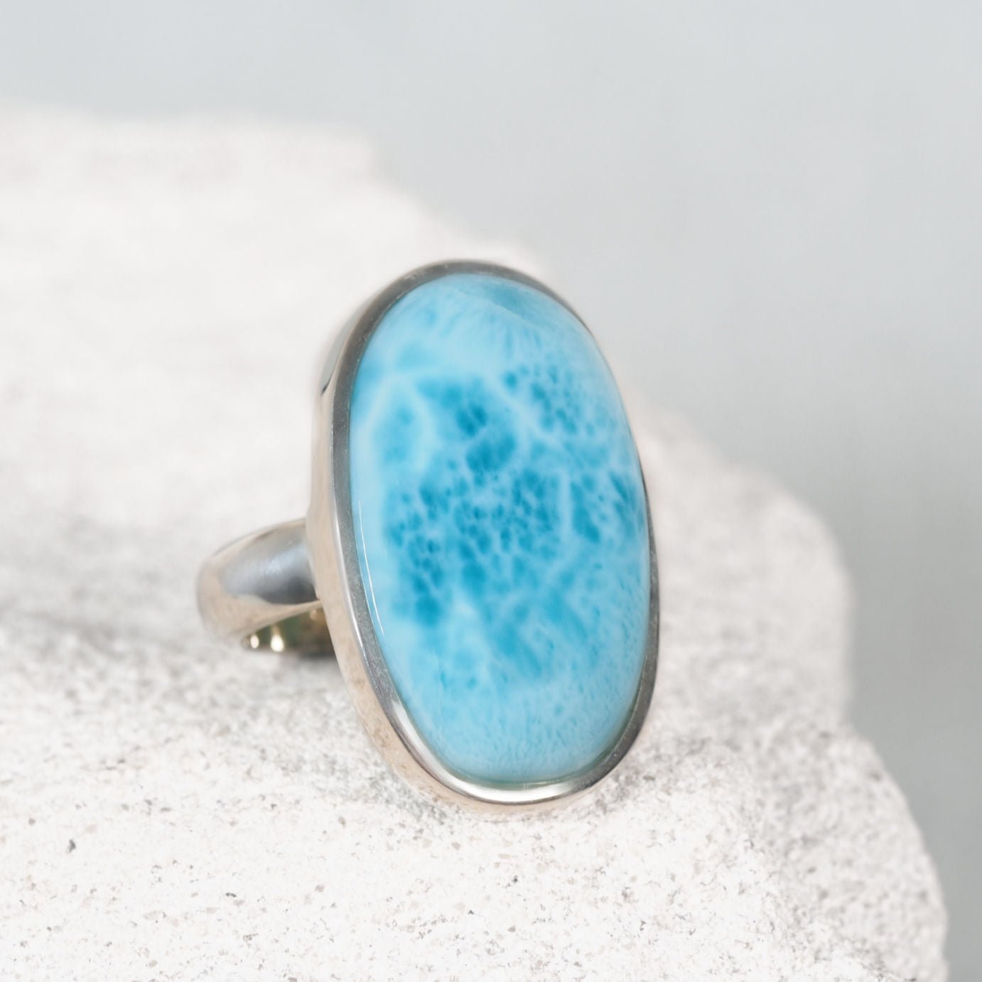 Blue Larimar Ring in a silver frame setting, displaying blue tones and soft whites