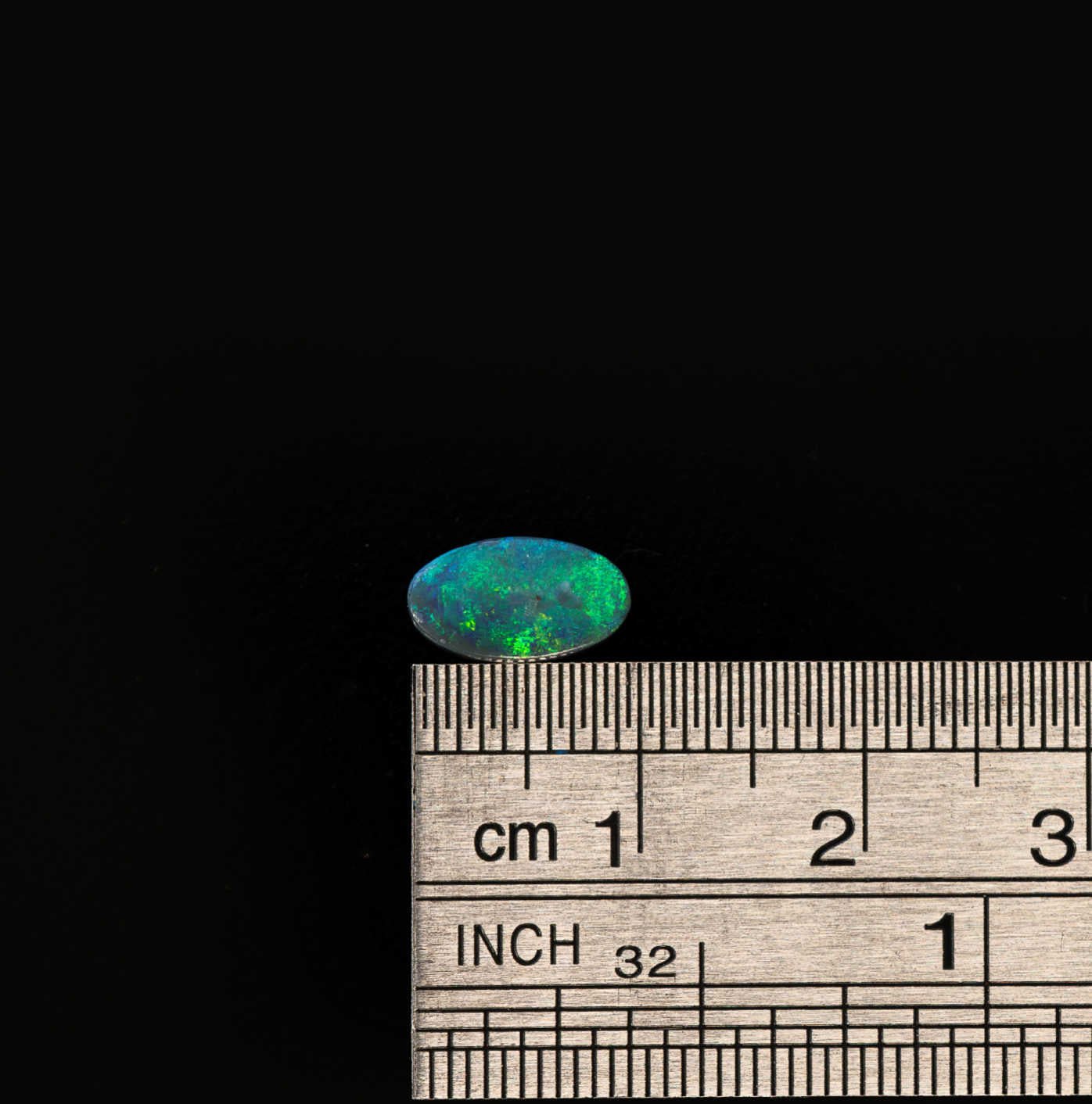 Natural black opal with dynamic green flashes, capturing the beauty of Lightning Ridge opal
