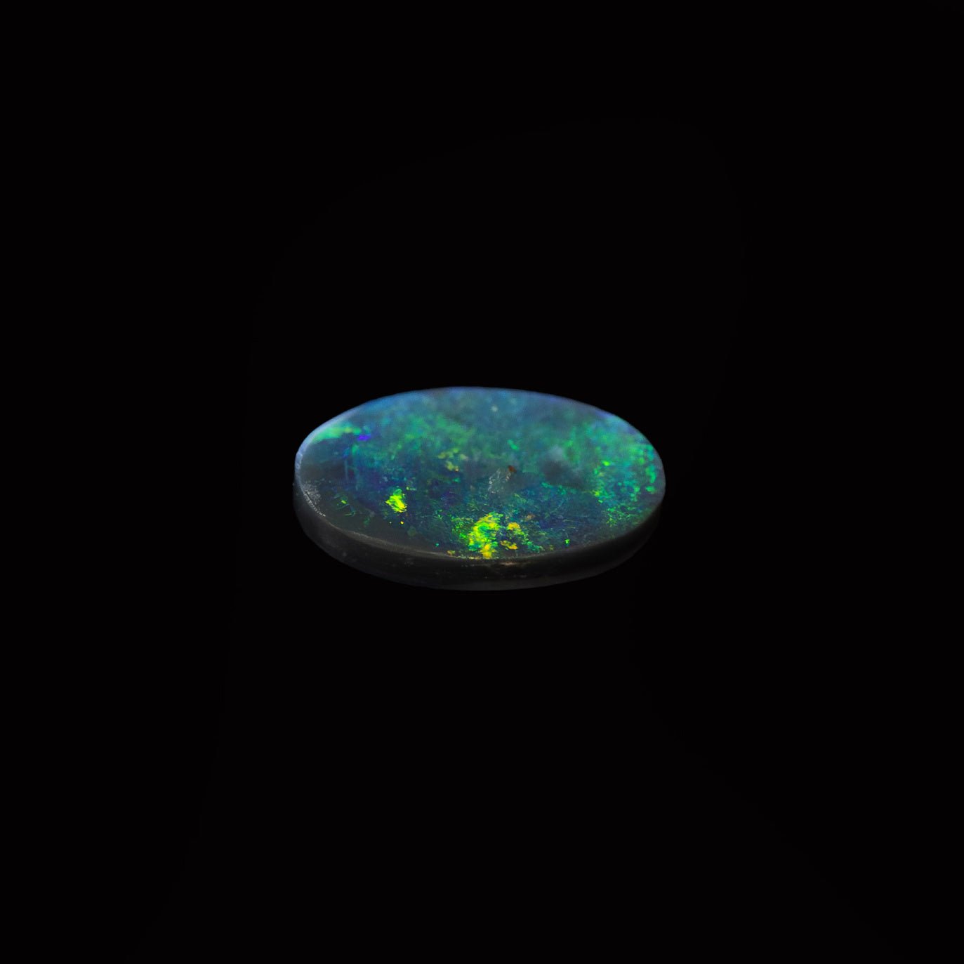 Shadowfern – natural black opal from Lightning Ridge with electric green flashes and rich dark body tone