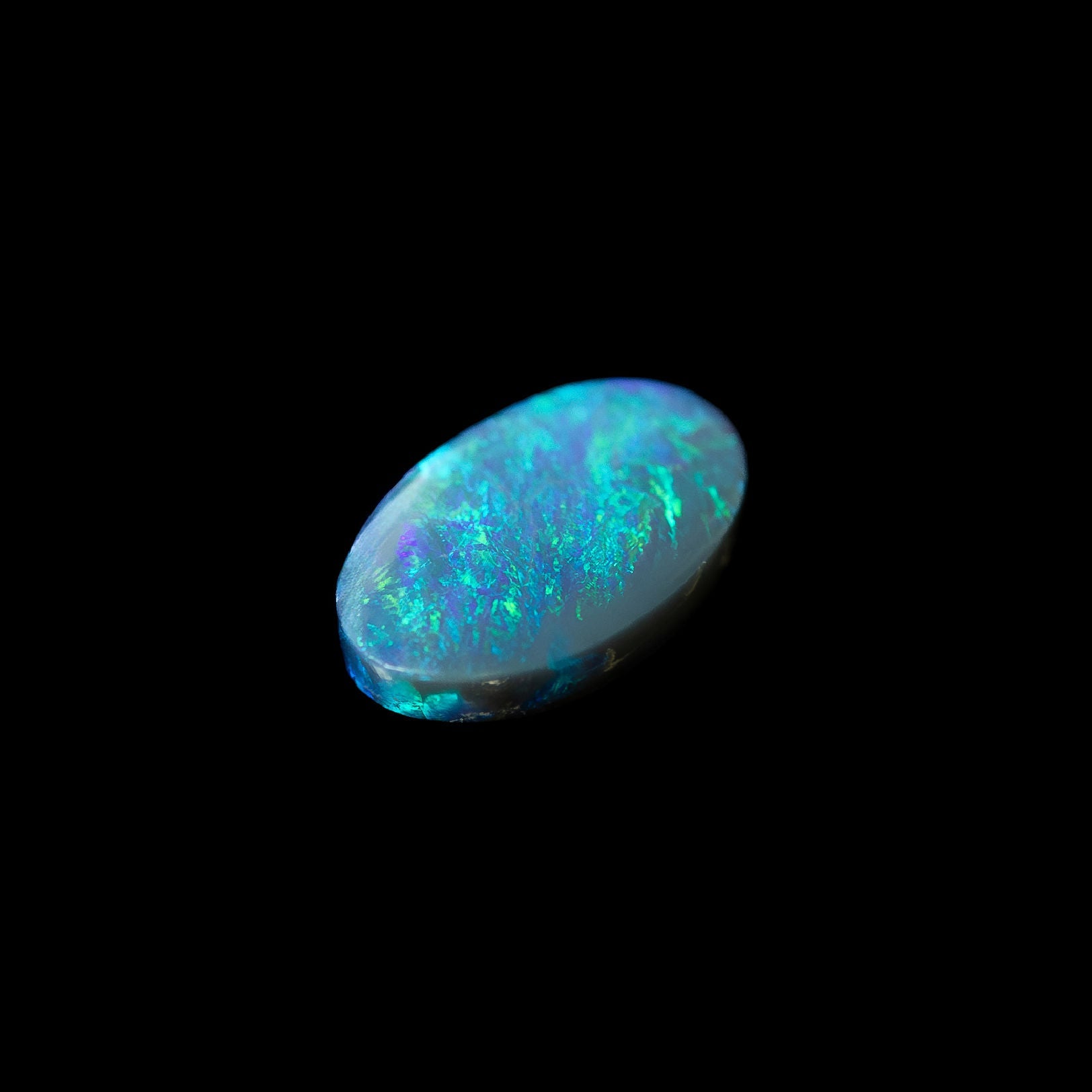 Oval-shaped semi-black Australian opal gemstone from Lightning Ridge