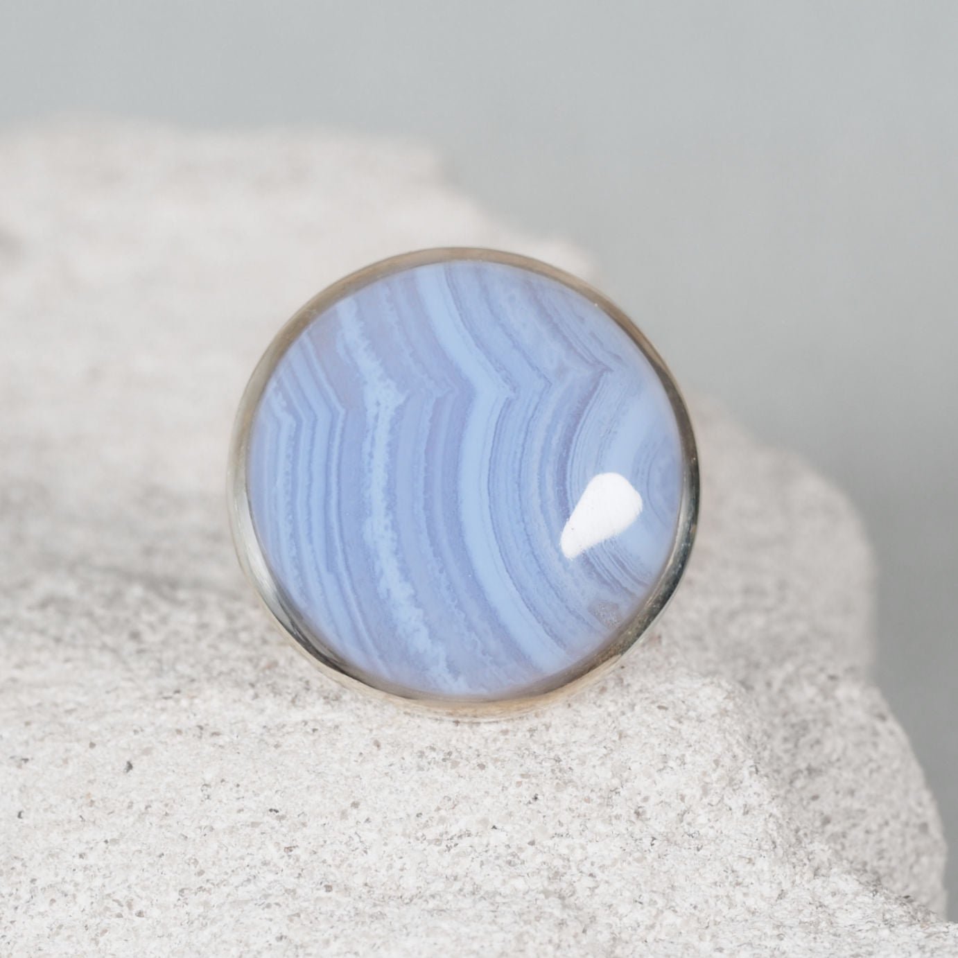 Blue Lace Agate in shape of oval displaying soft blue tones