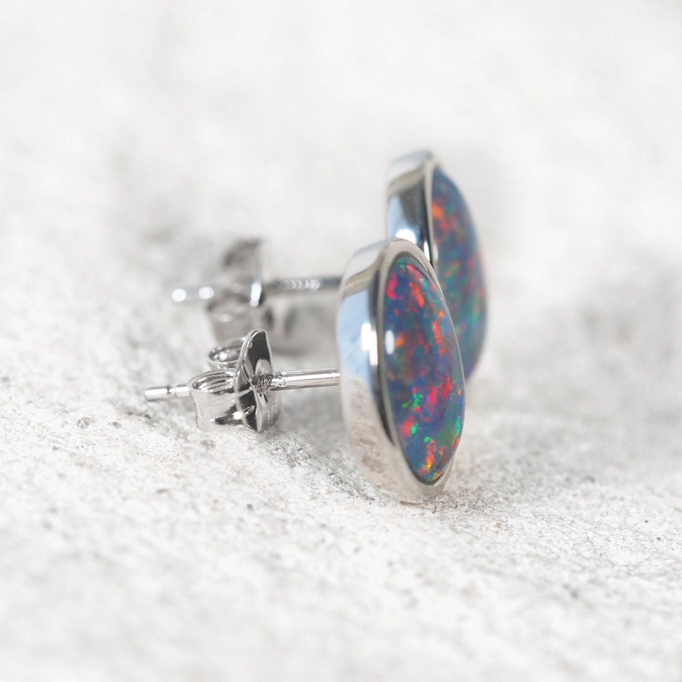 Oversized oval triplet opal stud earrings in polished sterling silver.