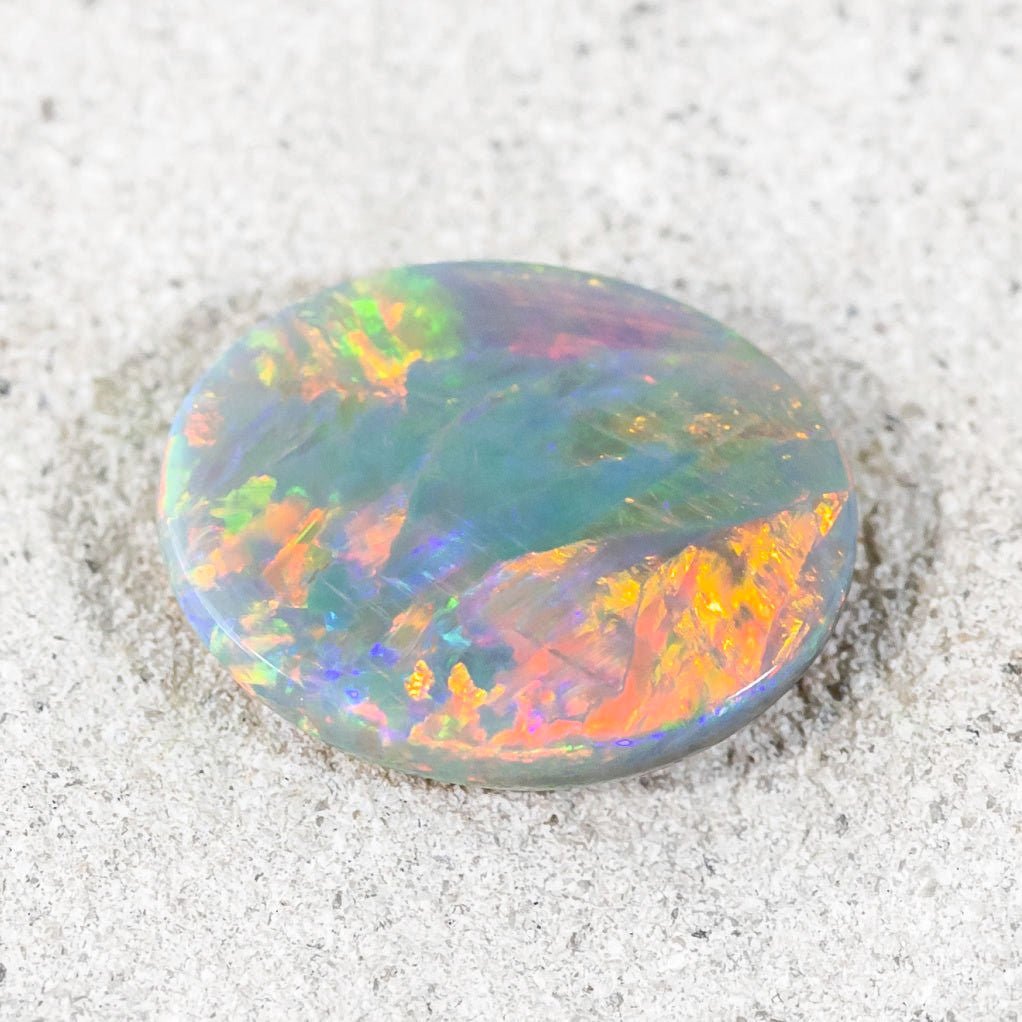 Close-up of natural semi-black opal ‘Star of the Outback’ with crystal clarity and vibrant play-of-colour.