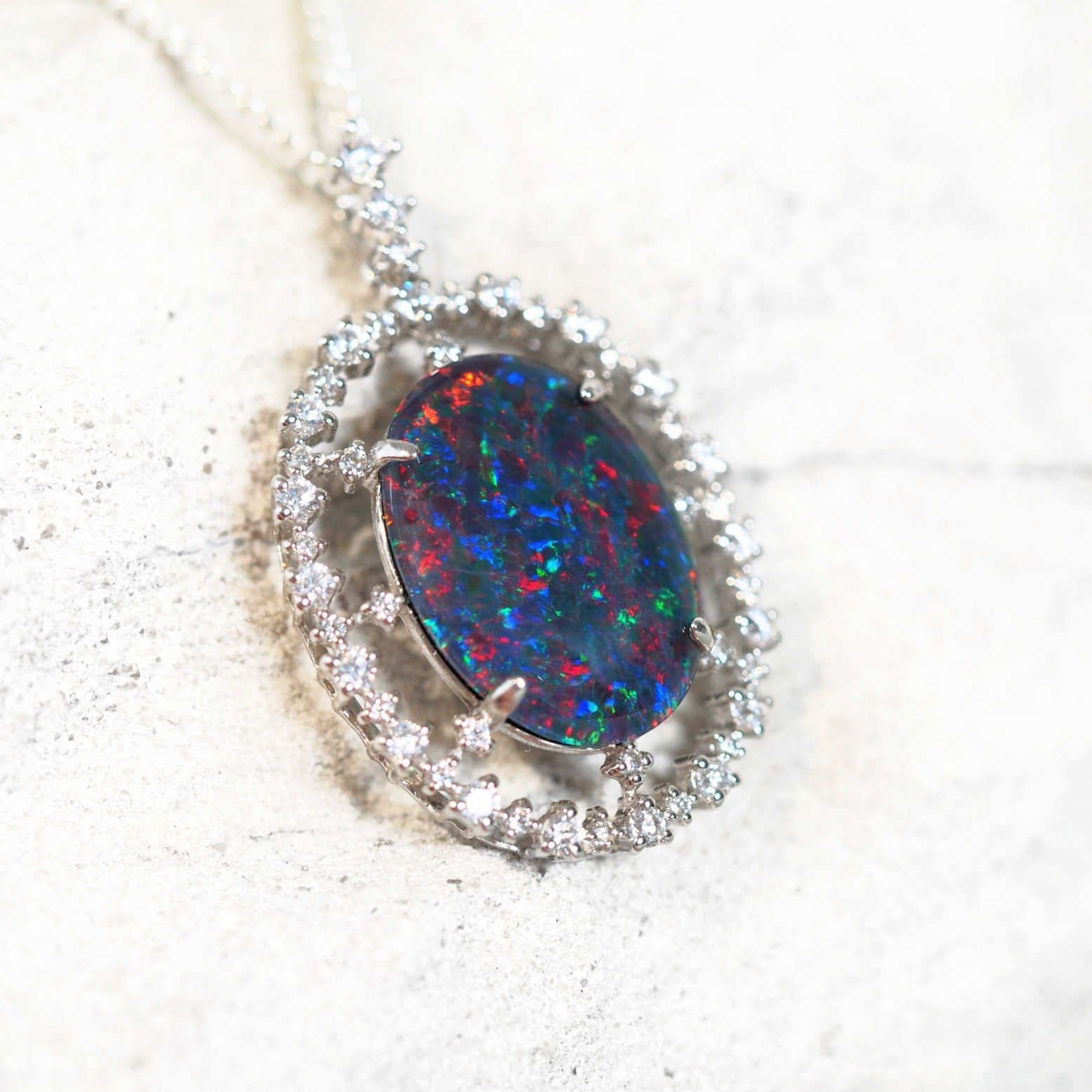 statement opal pendant with a ring of diamantes