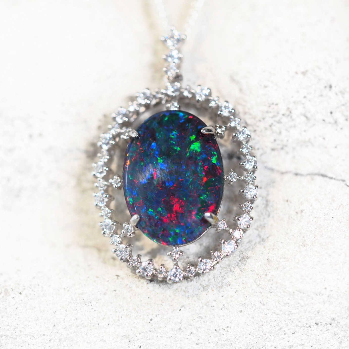 colourful opal pendant surrounded by 47 sparkling cubic zirconias