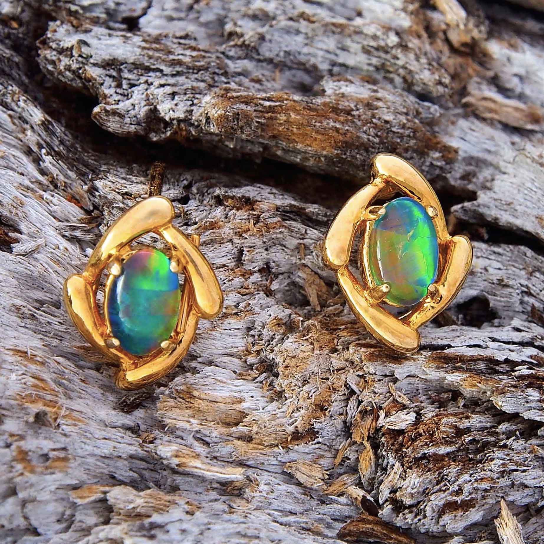 Swirl design gold plated sterling silver stud earrings claw set with colourful oval Australian triplet opals.